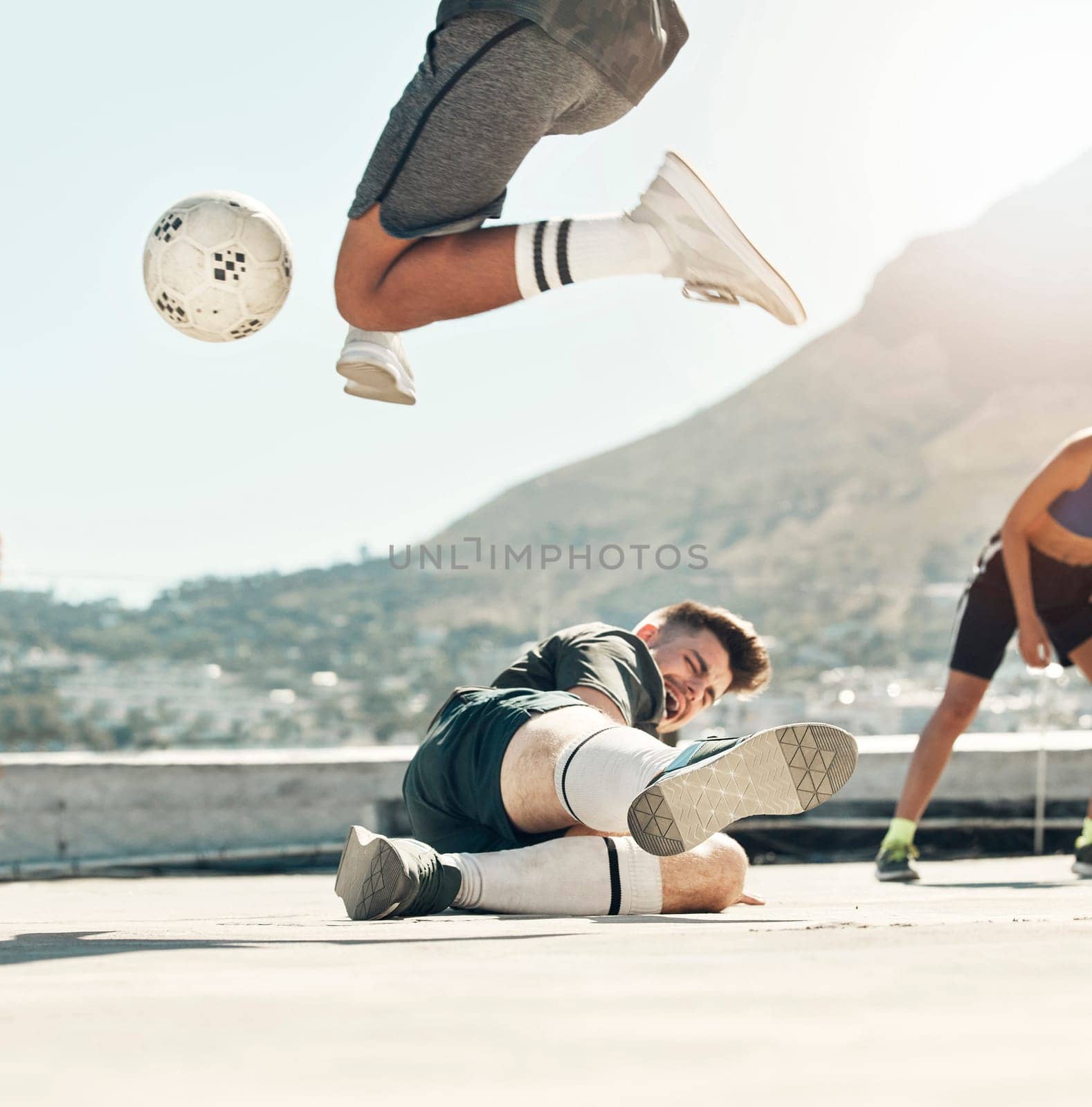 Ball, soccer and rooftop game with men sports training activity together fitness workout in city. Diversity, football competition and friends lifestyle exercise for health and wellness outdoors by YuriArcurs