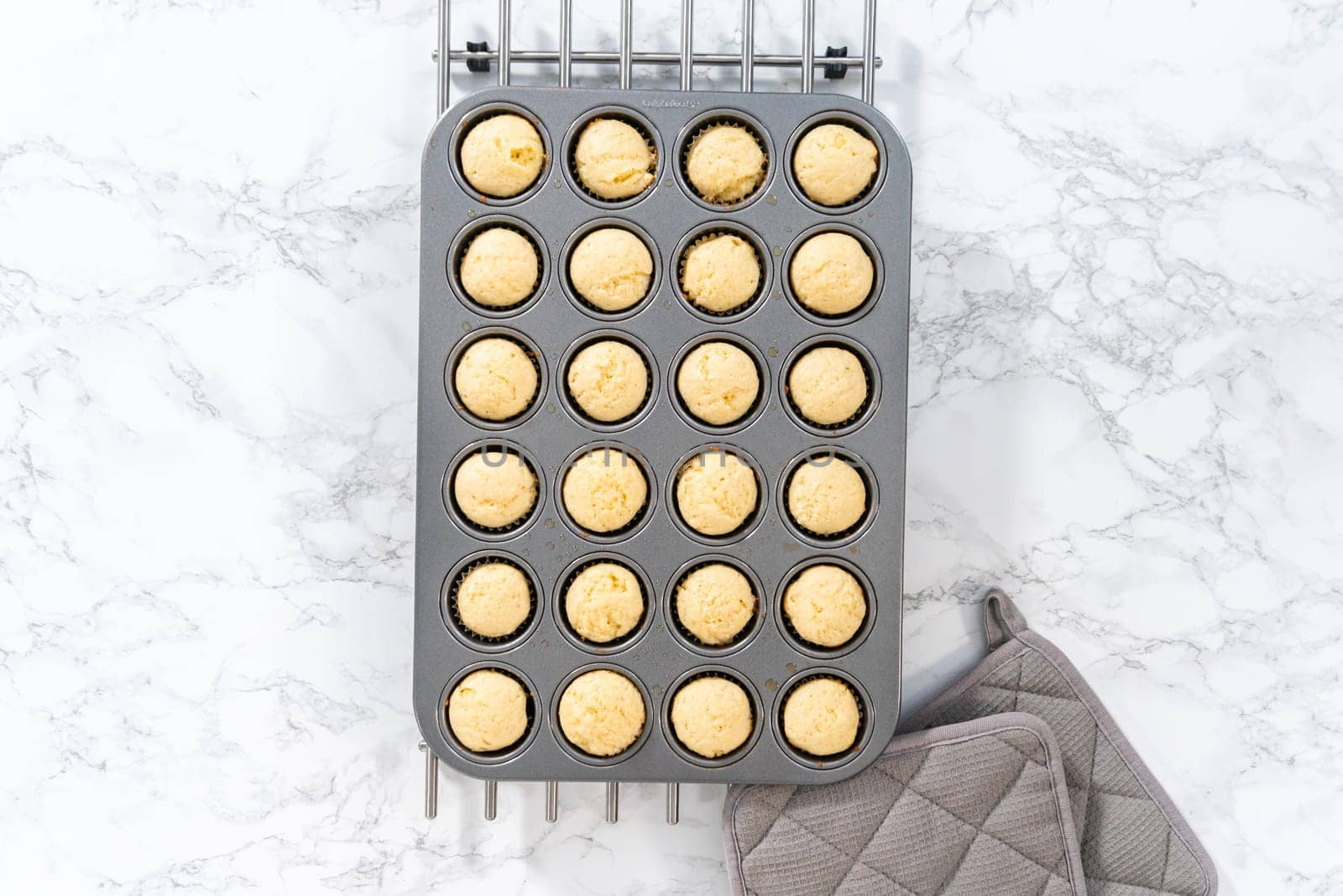 Flat lay. Cooling freshly baked American flag mini cupcakes on a kitchen counter.