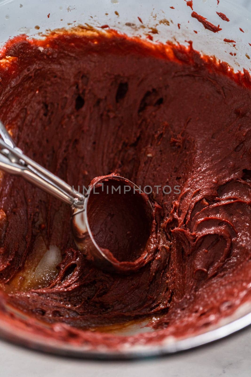 Filling metal bundt cake pan with cake butter to bake red velvet bundt cake with cream cheese glaze