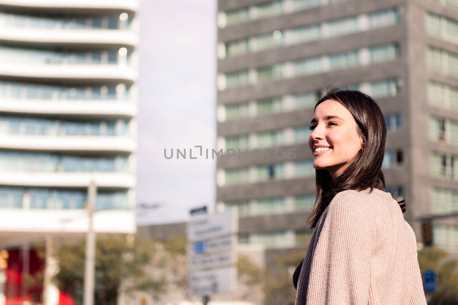 young woman walking city streets at morning sunrise, concept of happiness and urban lifestyle, copy space for text