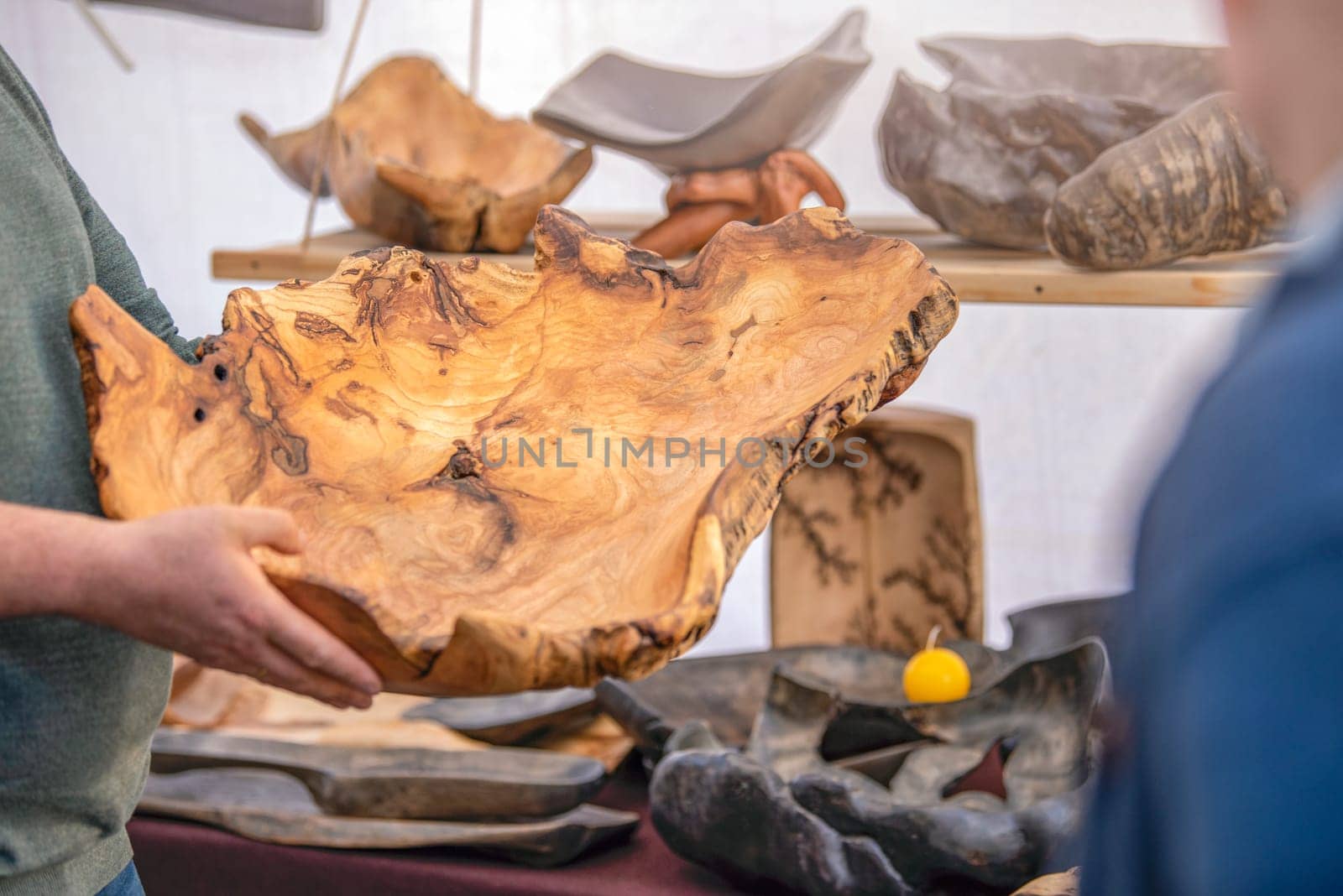 Manufacture and sale of wooden utensils. Large plates and trays made from exotic wood roots, handmade furniture and accessories purchase, craft and small business concept. High quality photo