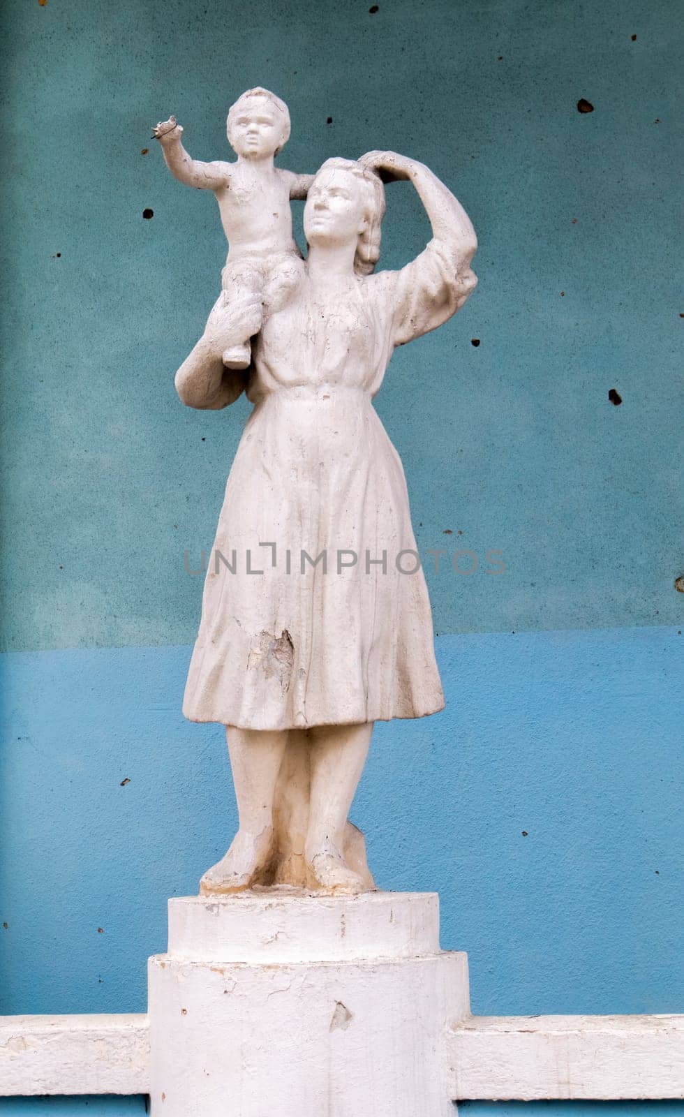 A statue of a mother and child that was damaged by shelling. A statue battered by rocket fragments stands at the bombed-out cultural center. War in Ukraine. Ukraine, Irpin - May 06, 2023