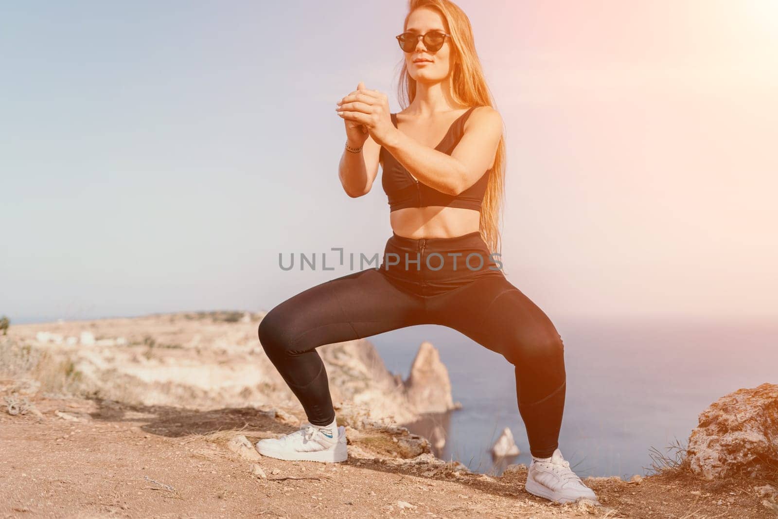 Fitness woman sea. Outdoor workout on yoga mat in park near to ocean beach. Female fitness pilates yoga routine concept. Healthy lifestyle. Happy fit woman exercising with rubber band in park. by panophotograph