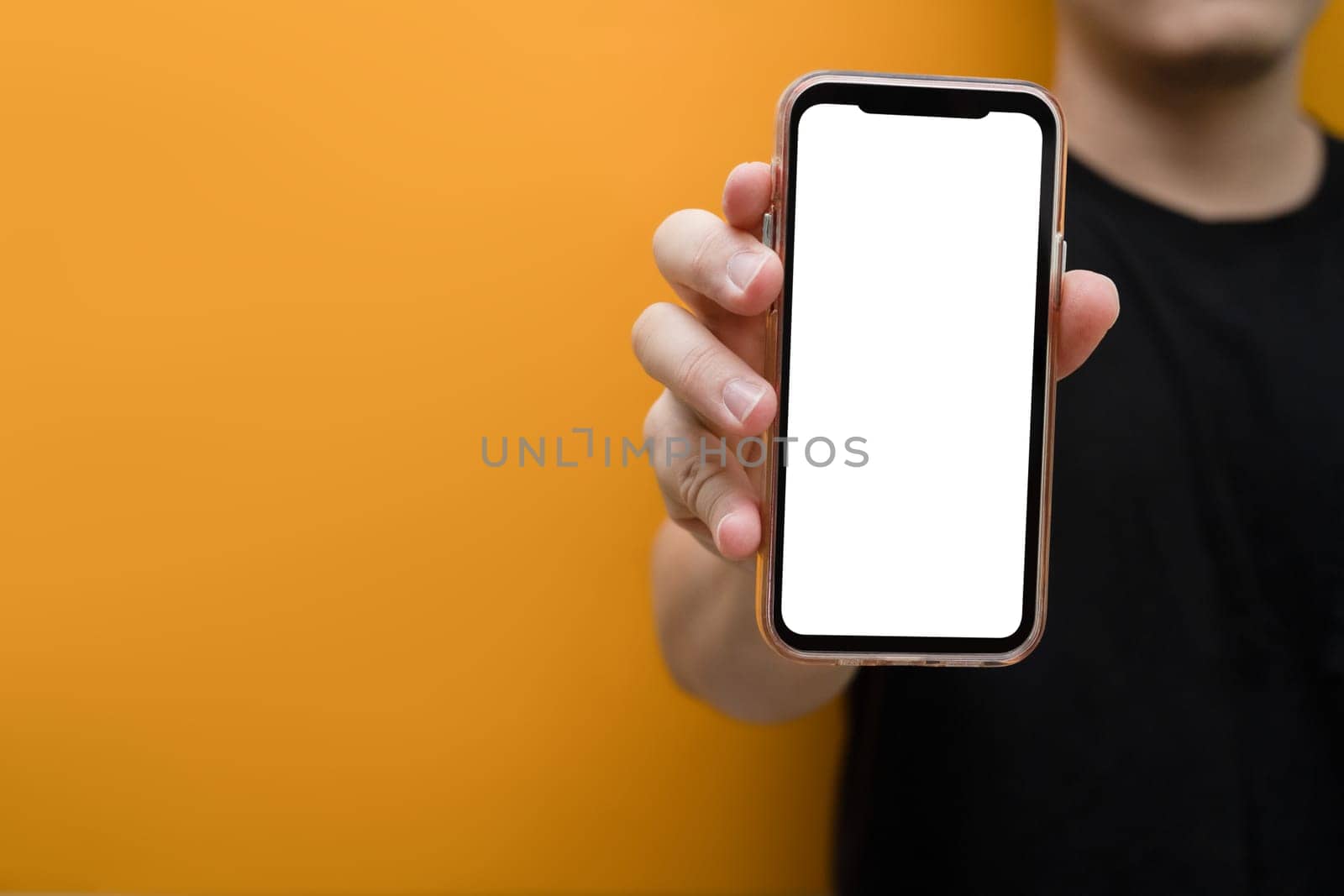 Closeup view of man hand holding mockup smartphone. Blank screen for your own webpage or advertise text.
