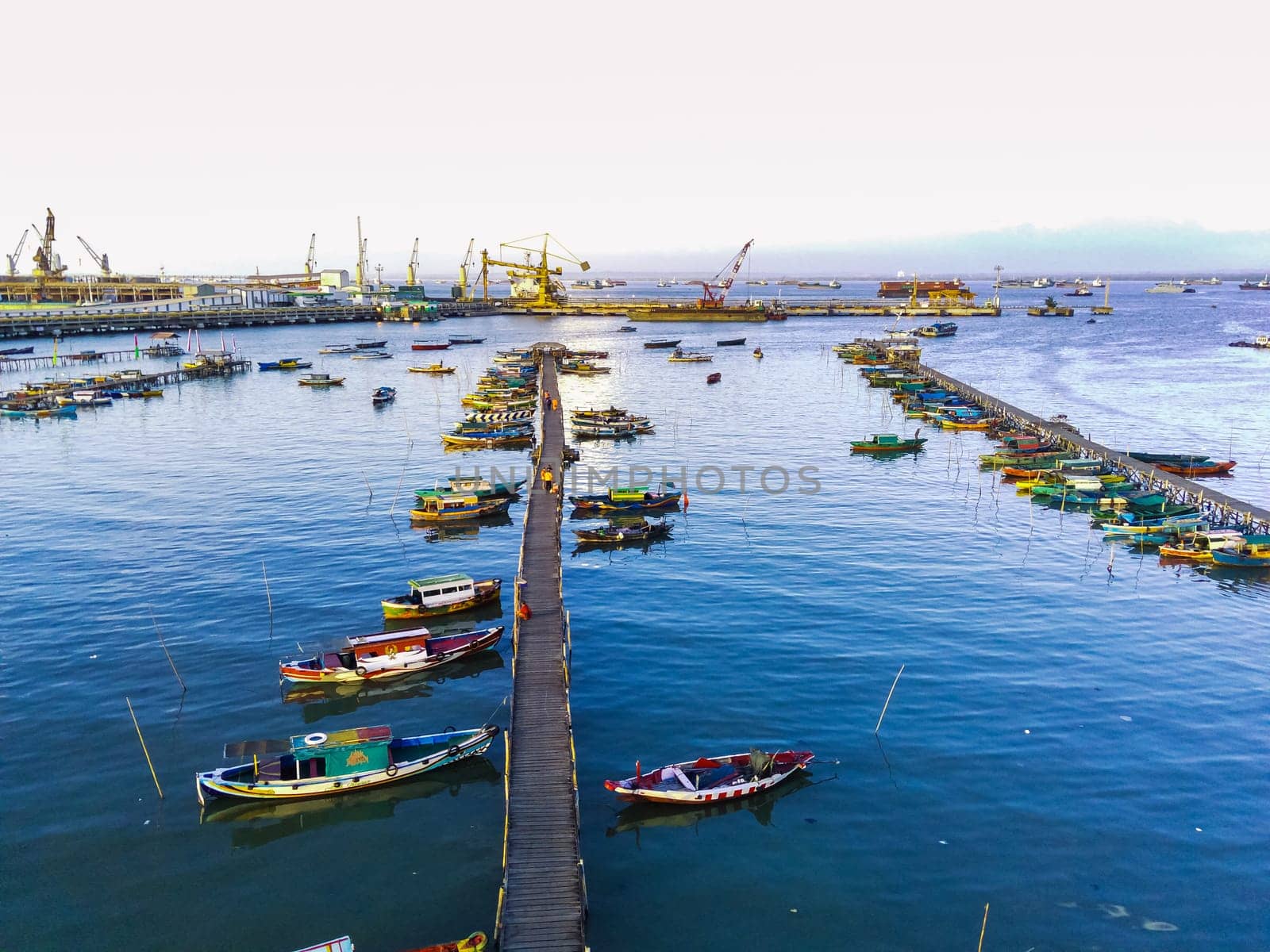 Aerial top down on traditional colourful asian fisherman boats moored in Gresik, Indonesia. Drone Photography. Aerial Photography.