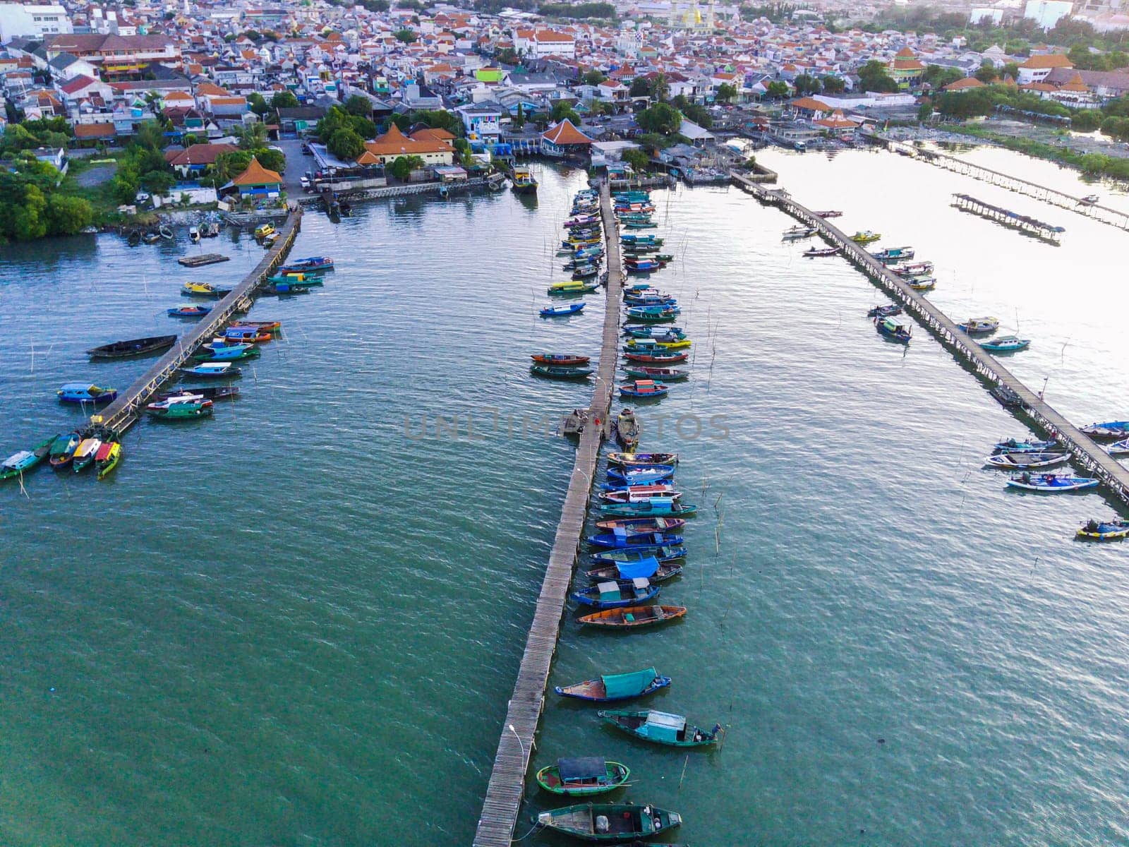 Aerial top down on traditional colourful asian fisherman boats moored in Gresik, Indonesia. Drone Photography. Aerial Photography.