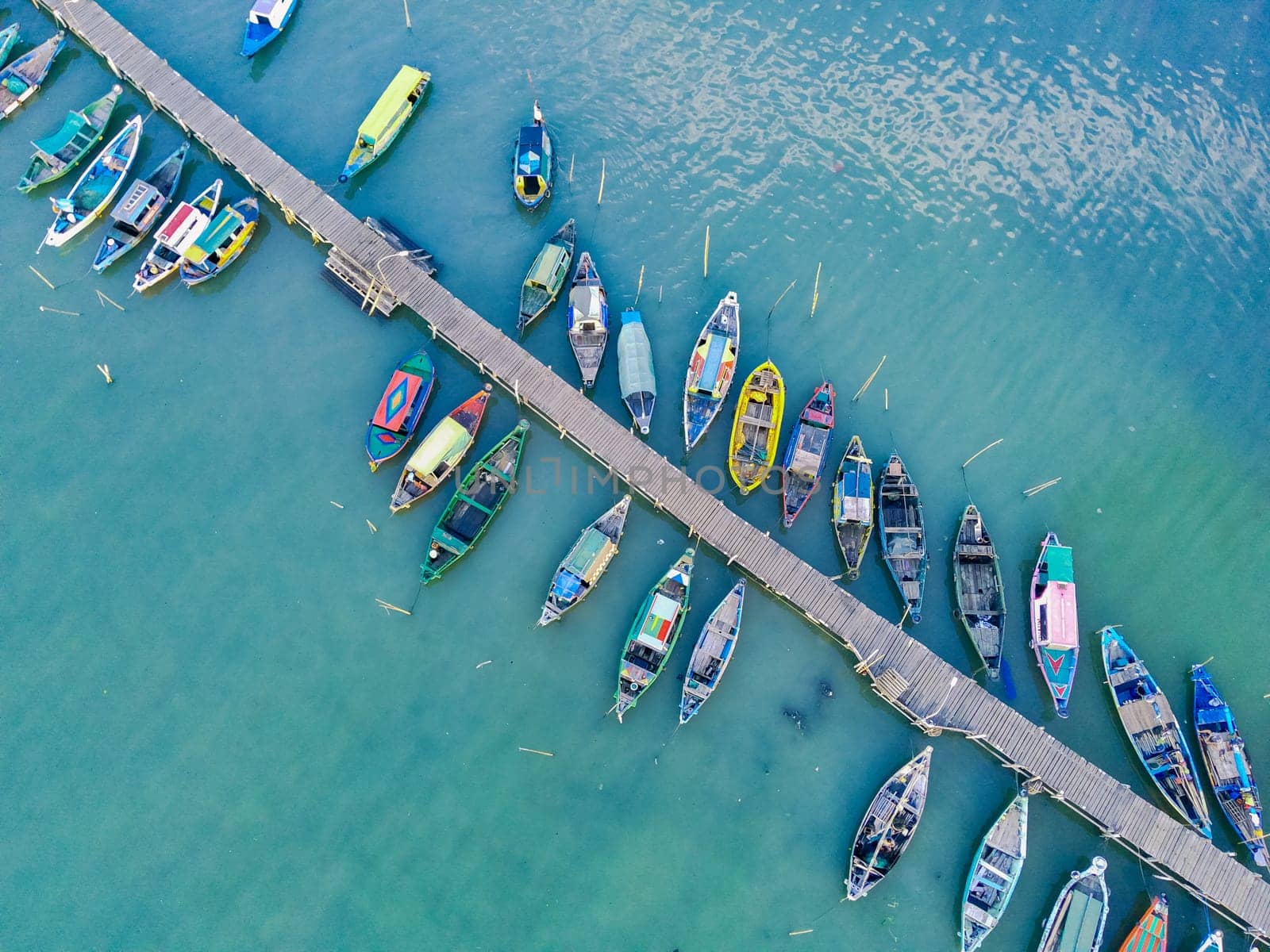 Aerial top down on traditional colourful asian fisherman boats moored in Gresik, Indonesia. Drone Photography. Aerial Photography.
