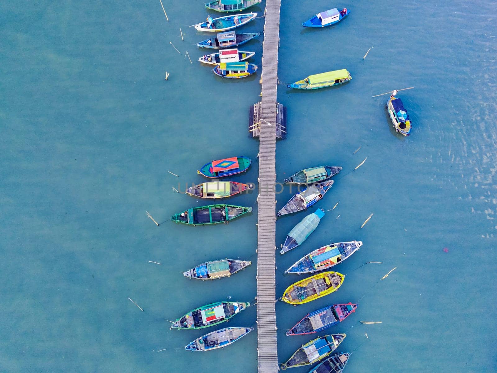 Aerial top down on traditional colourful asian fisherman boats moored in Gresik, Indonesia. Drone Photography. Aerial Photography.