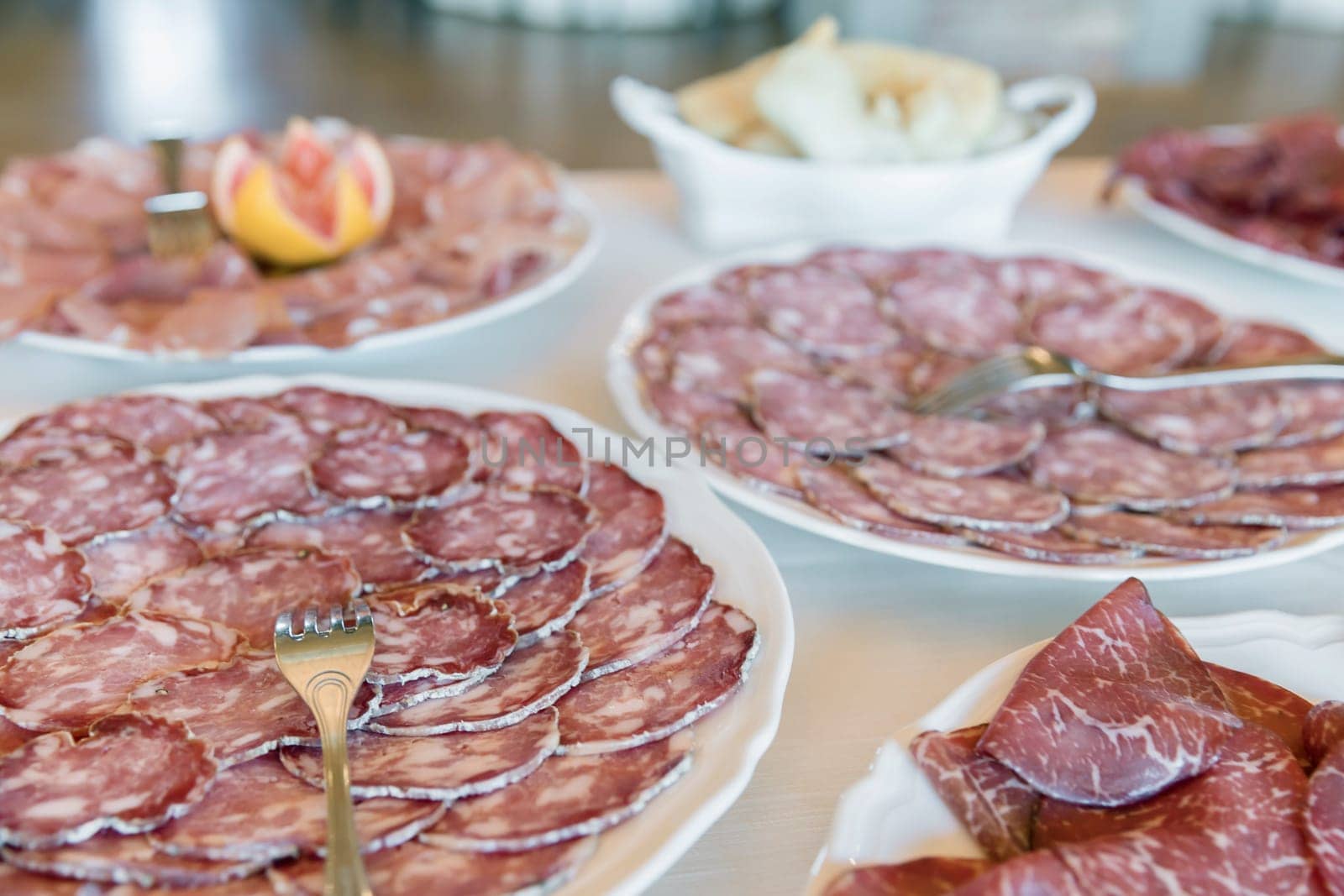 Cured meat in plates, ready for served to an event or party. Appetizer.