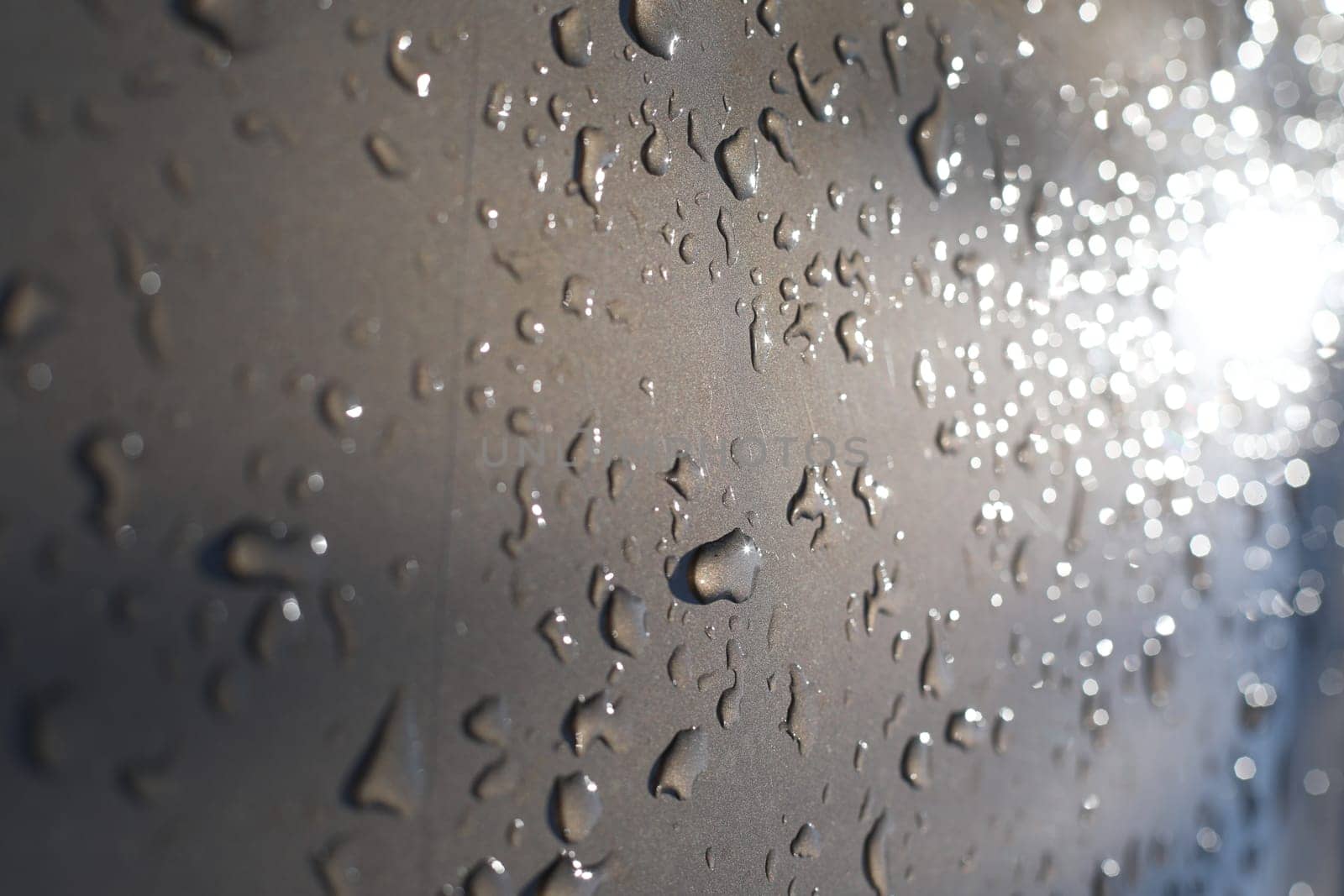 Drops of water on a color background. Selective focus. Gray. High quality photo