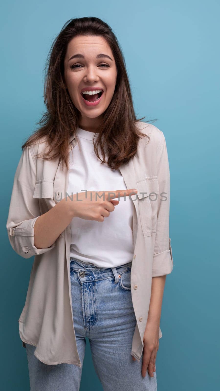 young brunette female adult in casual shirt gesturing with her hands.