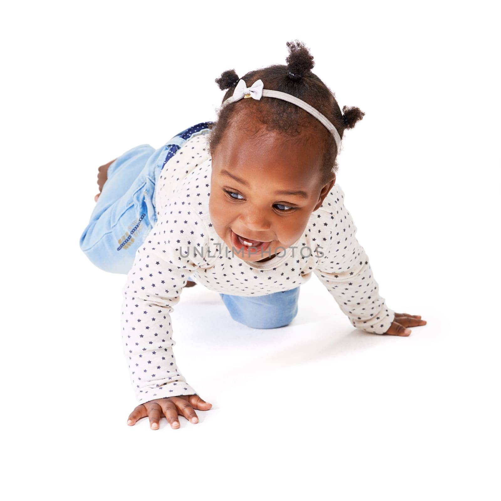 Studio shot of a baby girl crawling against a white background.