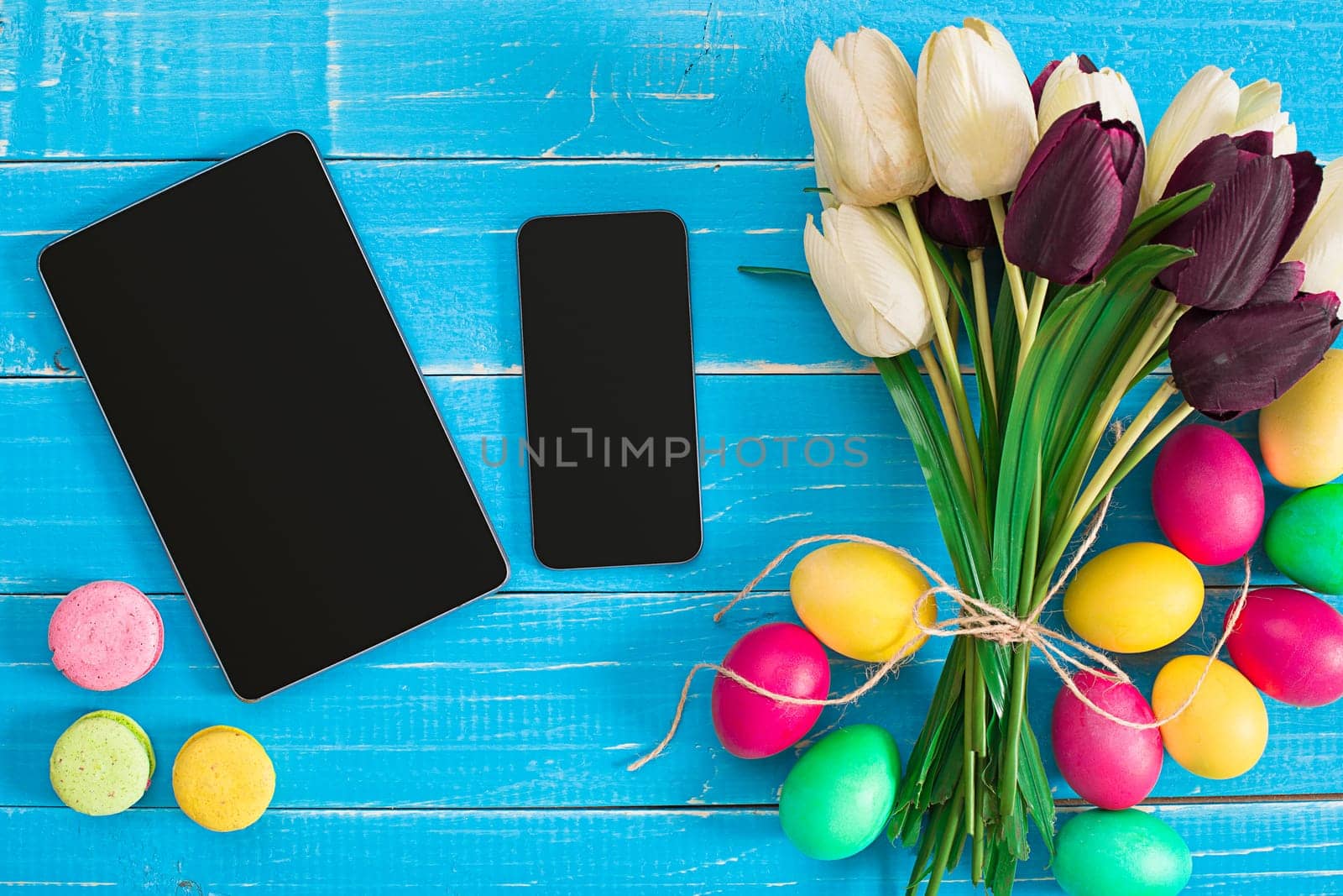 Easter eggs and tulips on blue wooden planks by nazarovsergey