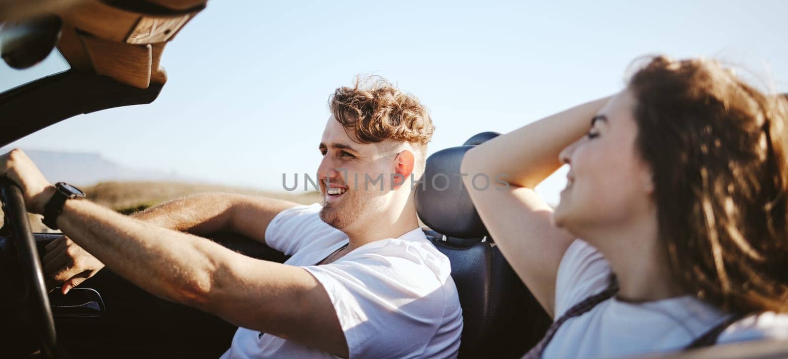 Road trip, happy couple and travel while in a convertible car for fresh air, adventure and journey with partner enjoying trip, love and freedom. Man and woman taking drive and traveling in Australia.
