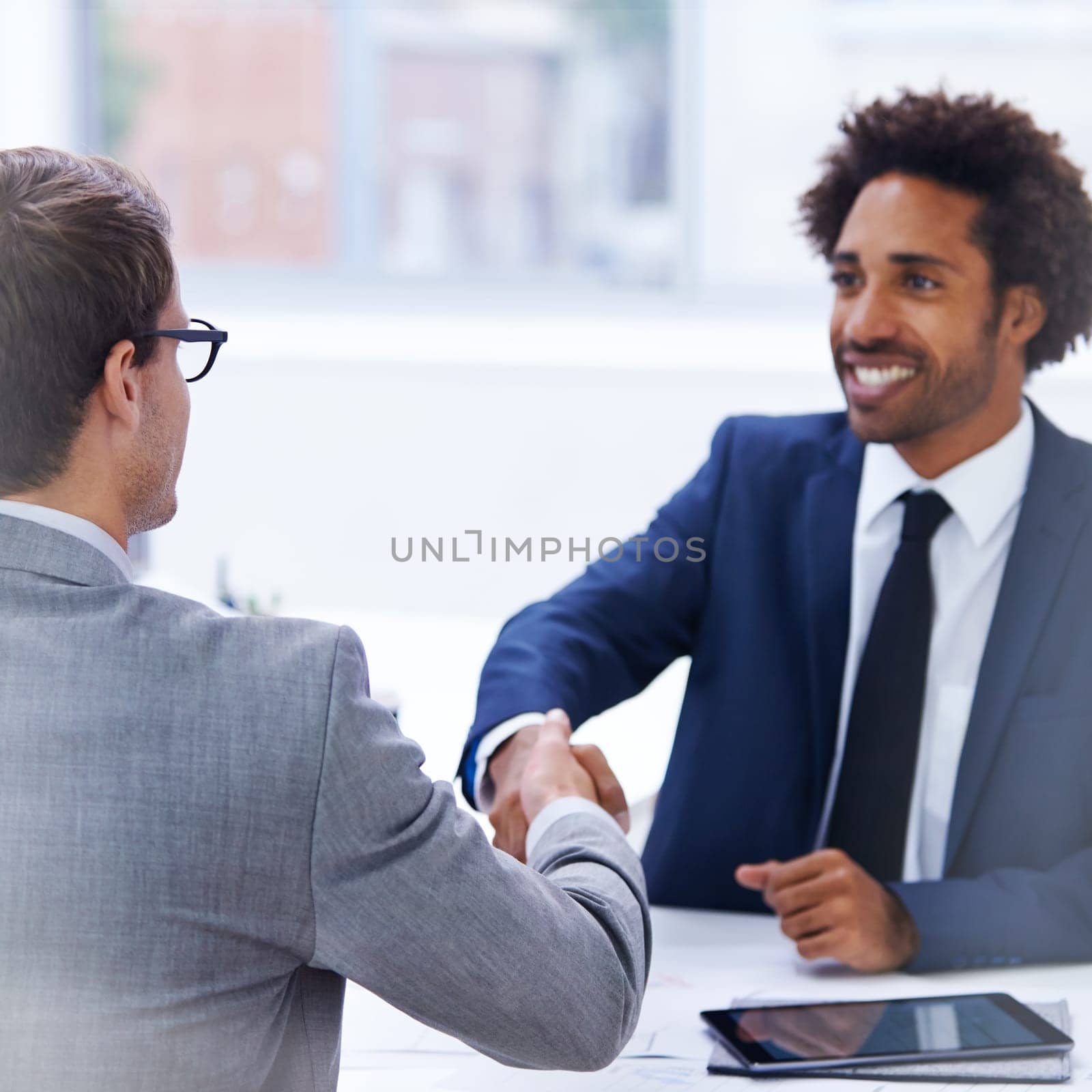 Feeling good about the meeting. Shot of businessmen shaking hands in an office