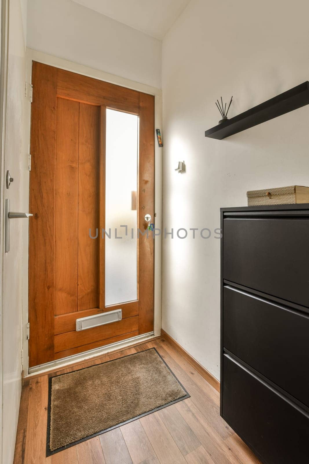 a wooden door in a room with a dresser by casamedia