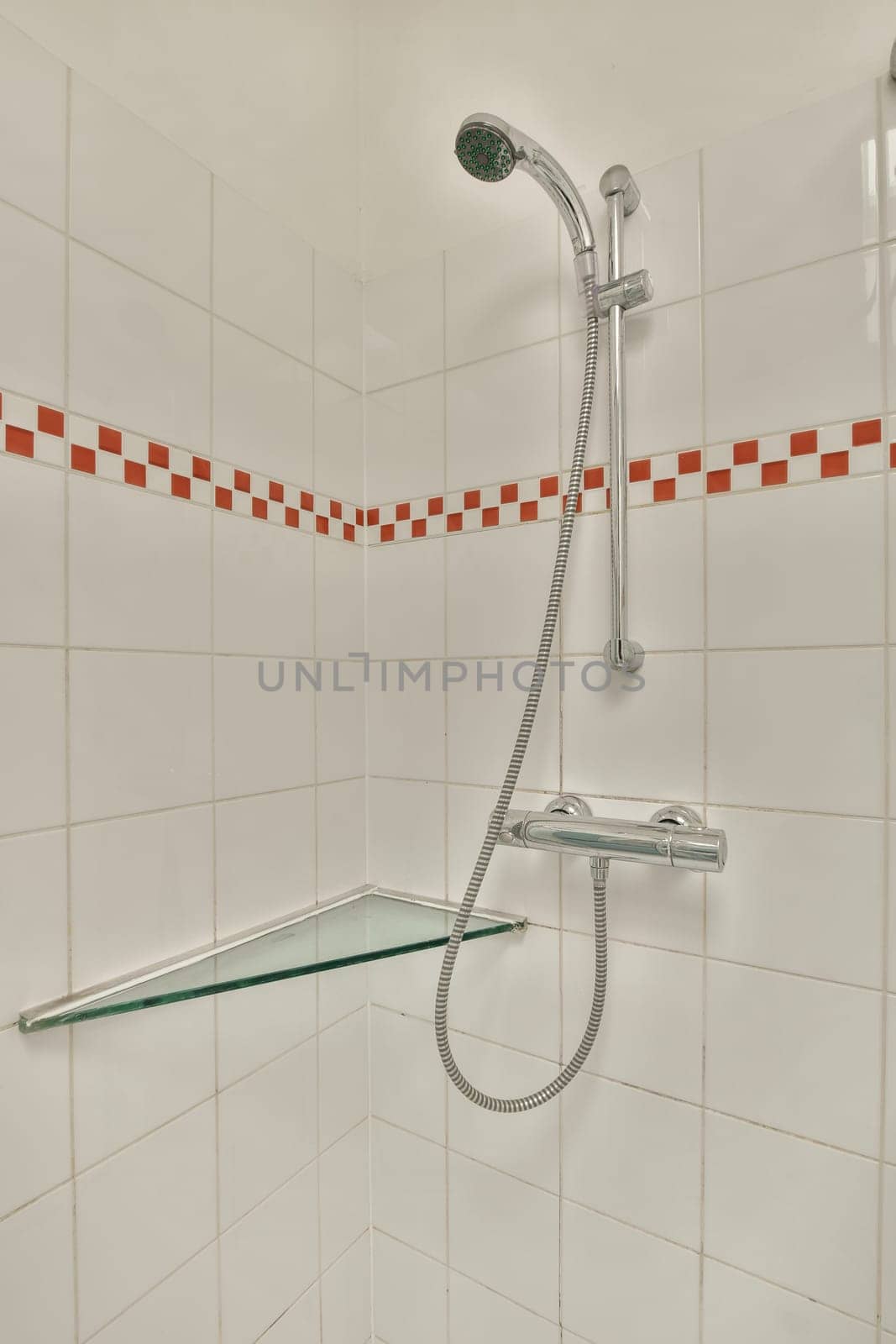 a shower in a bathroom with white tiled walls by casamedia