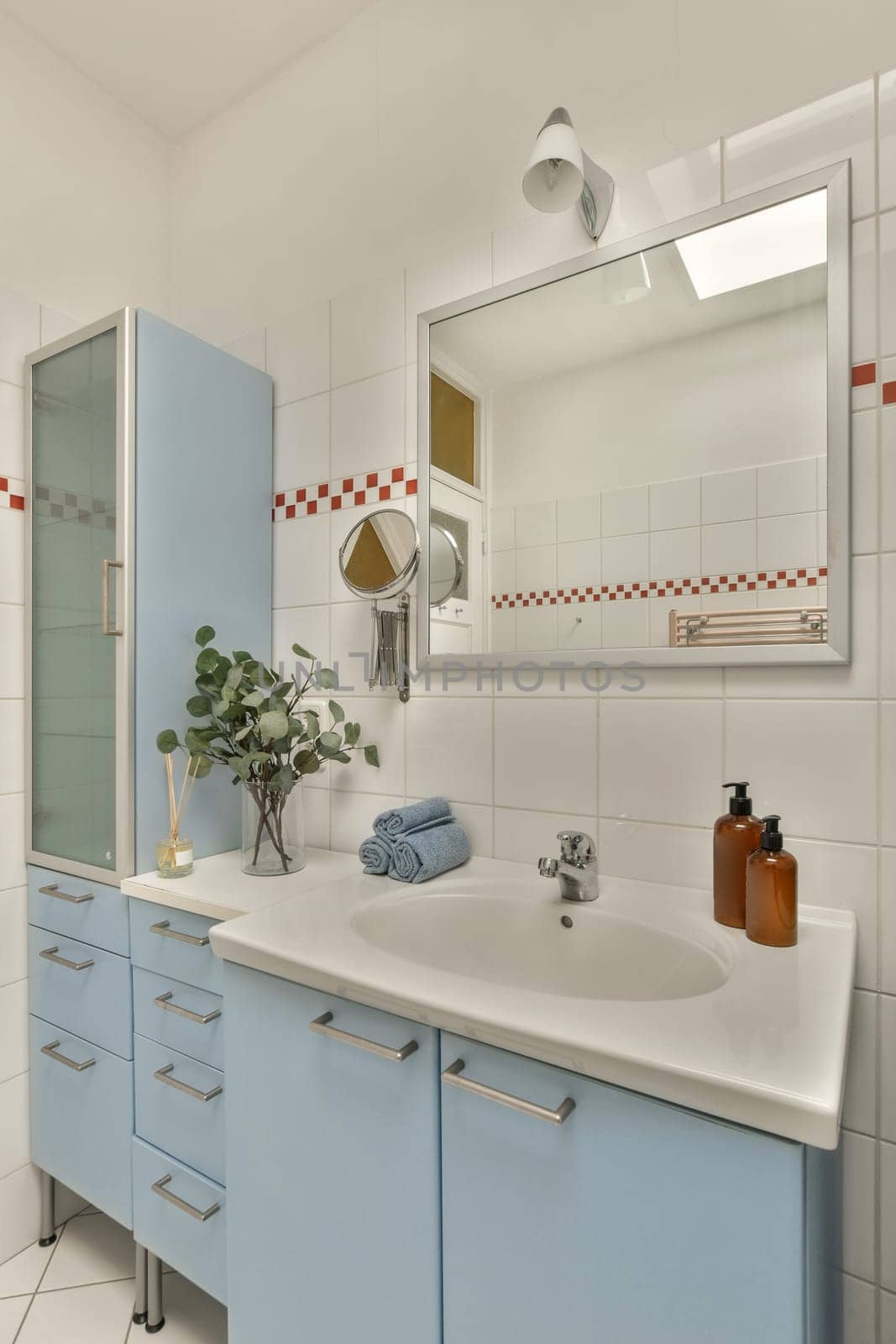 a blue and white bathroom with a sink and mirror by casamedia