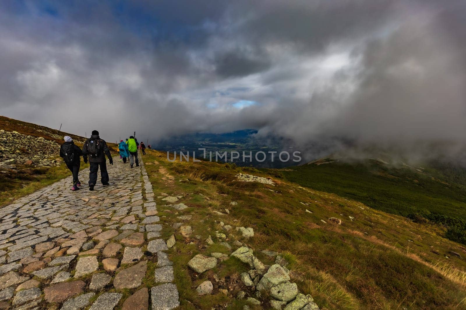 Long stony mountain trail over Sniezka mountain in Giant mountains with beautiful cloudy green landscape around by Wierzchu