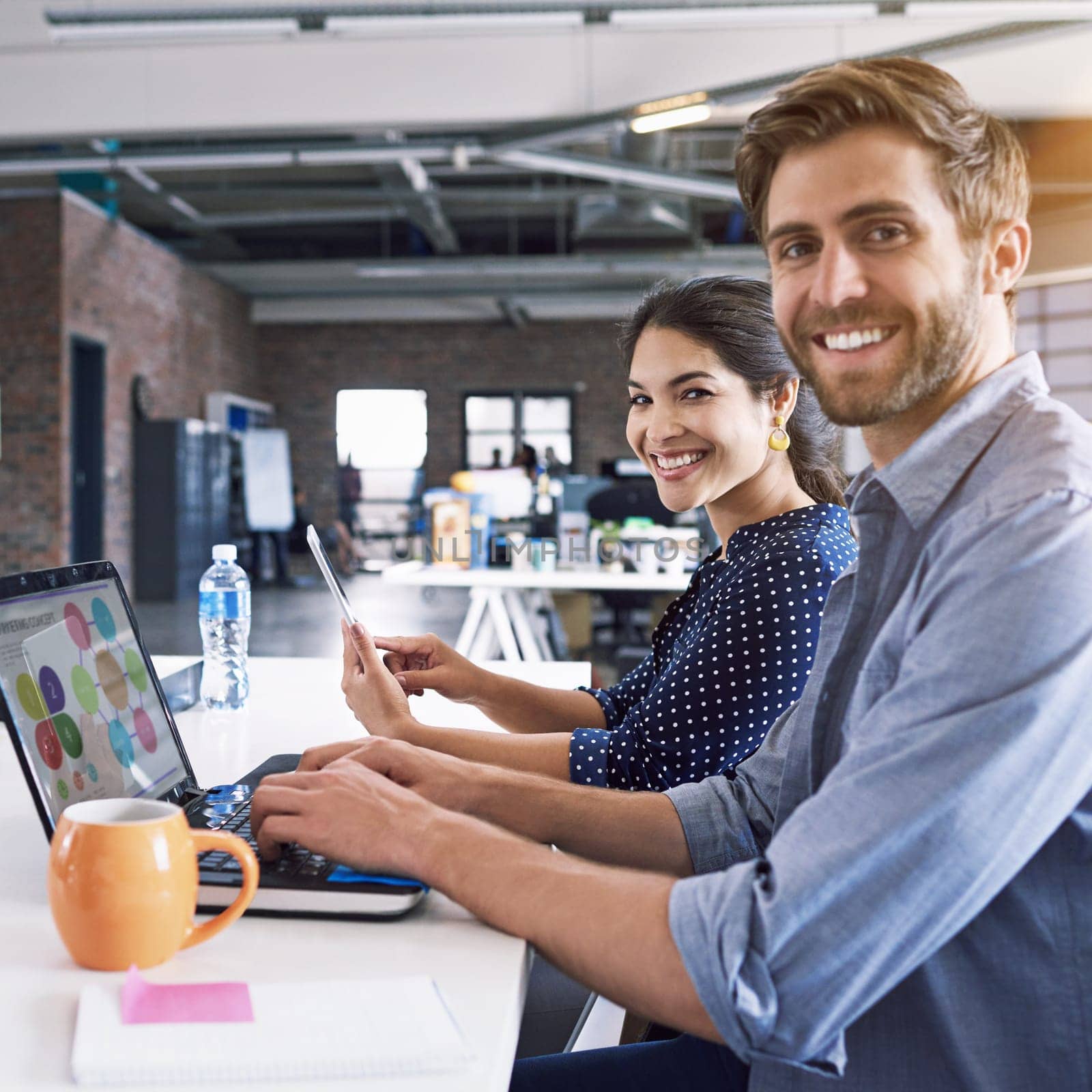 Smile, office and portrait of man and woman at desk with laptop at creative agency, working on project together. Leadership, partnership and happy employees or business partner at design startup
