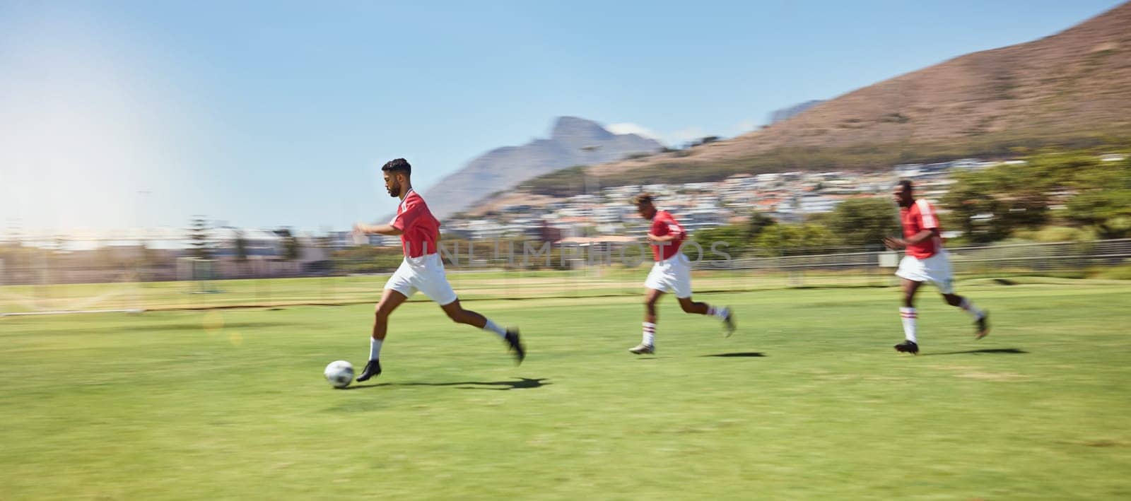 Soccer player, running and soccer ball team sports competition game, grass pitch and goals of winning score in South Africa. Motion blur professional athlete, football field action and outdoor energy.