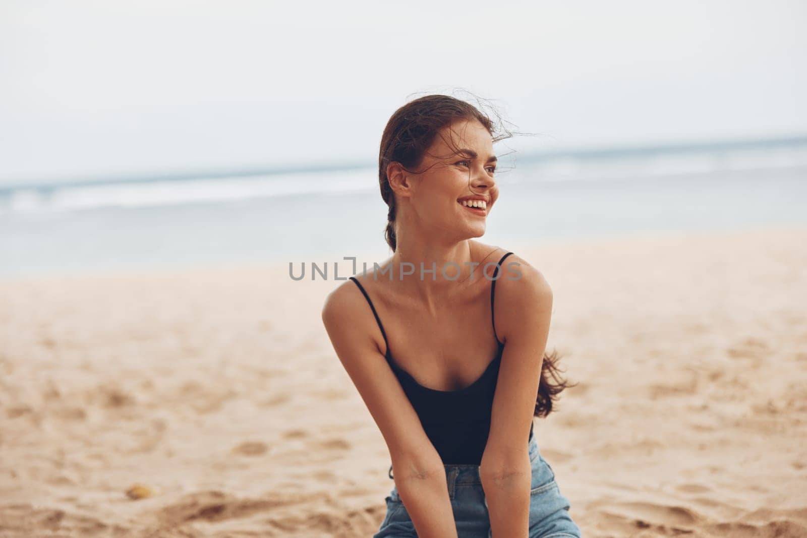 beach woman white view ocean young coast female smile beauty fashion sand happy vacation travel sitting carefree freedom body back sea nature