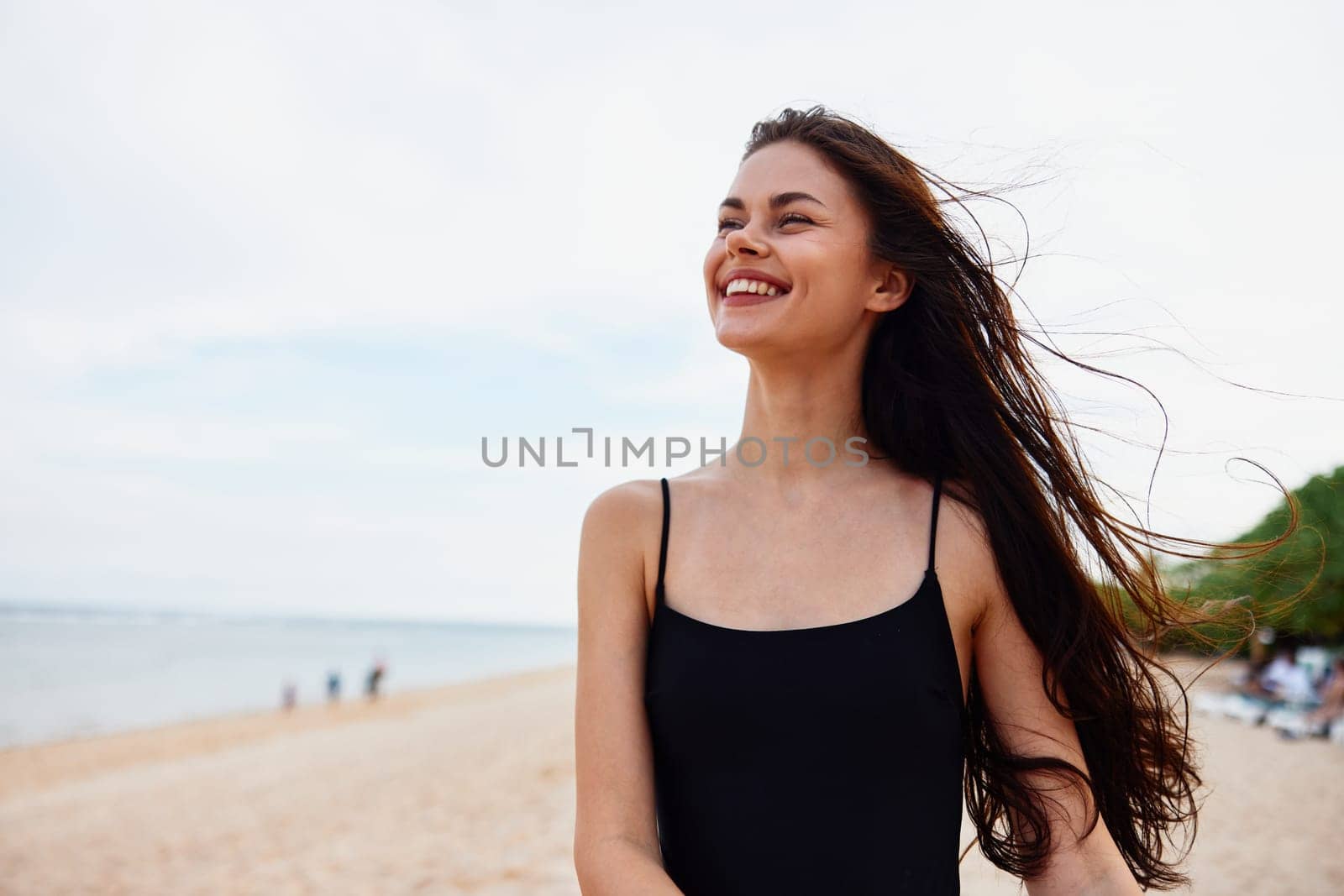 sea woman summer beach sand beauty hair peaceful smile ocean nature girl dress leisure vacation sunset long adult holiday caucasian smiling young