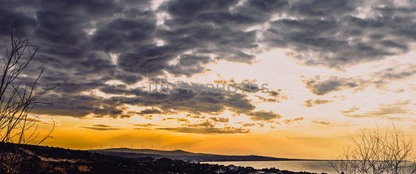 Abstract background sky Dawn Sunset Contrast dark shadow bright cloud sun orange silhouette above the mountains near the sea.