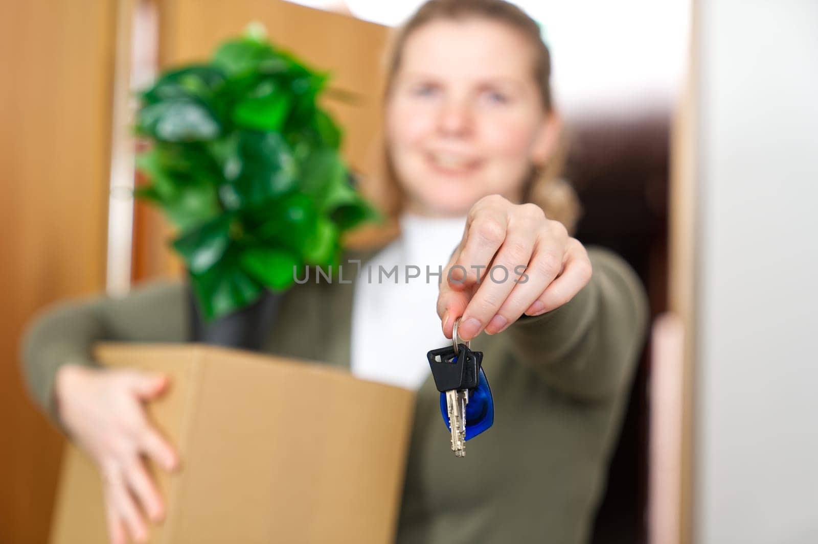 Starting new life. Overjoyed woman hold keys from new apartment or home. new life starts now by PhotoTime