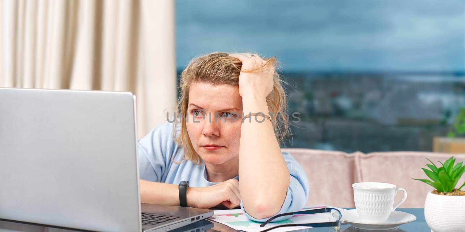 Unhappy tired woman at home office working with laptop. Stress, depression, loneliness, fatigue, burnout concept. Businesswoman work at computer, feeling unwell, suffering from stress, headache.