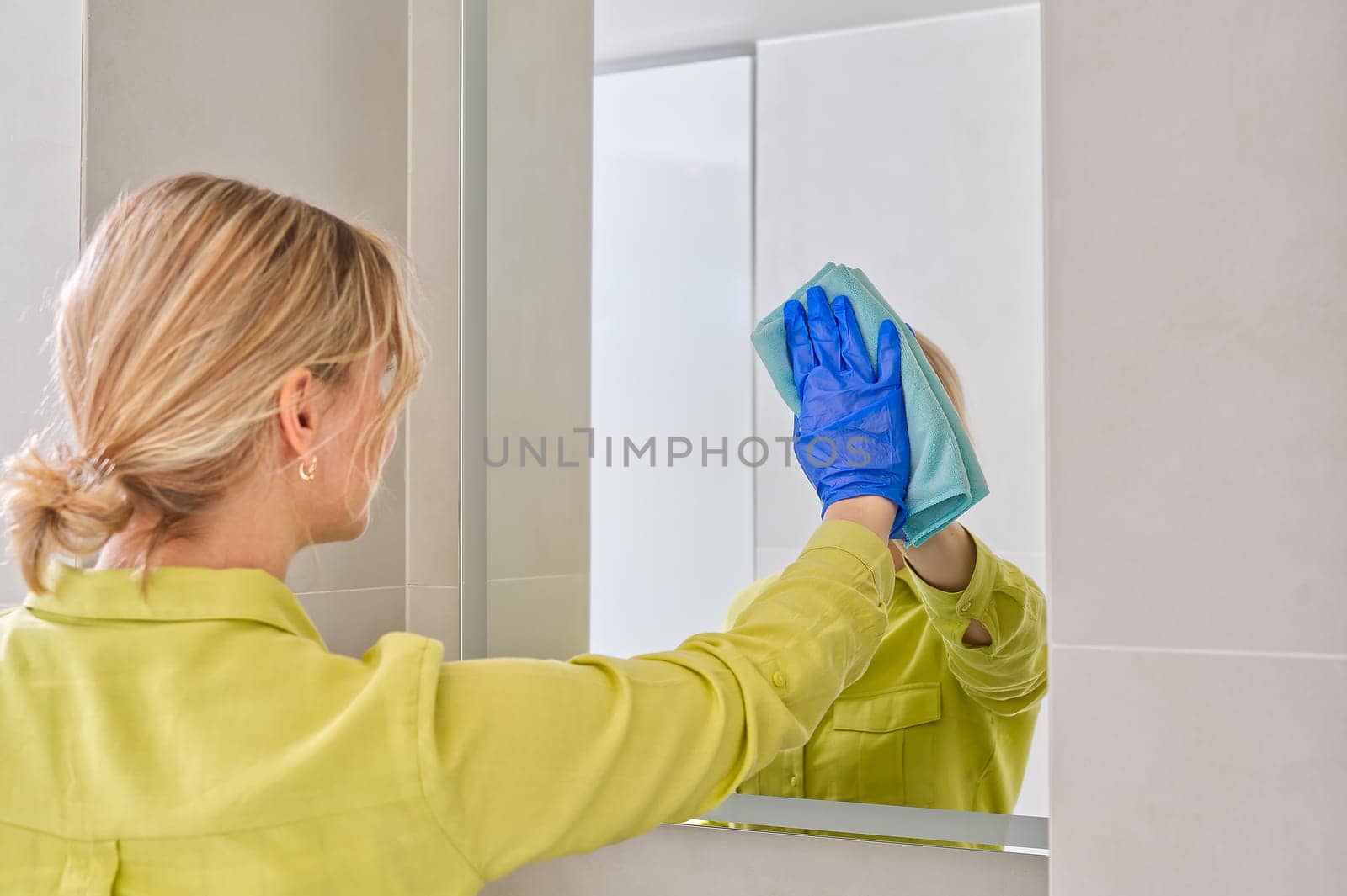 cleaning company. hotel maid microfiber cloth washing cleaning a mirror. household service concept by PhotoTime