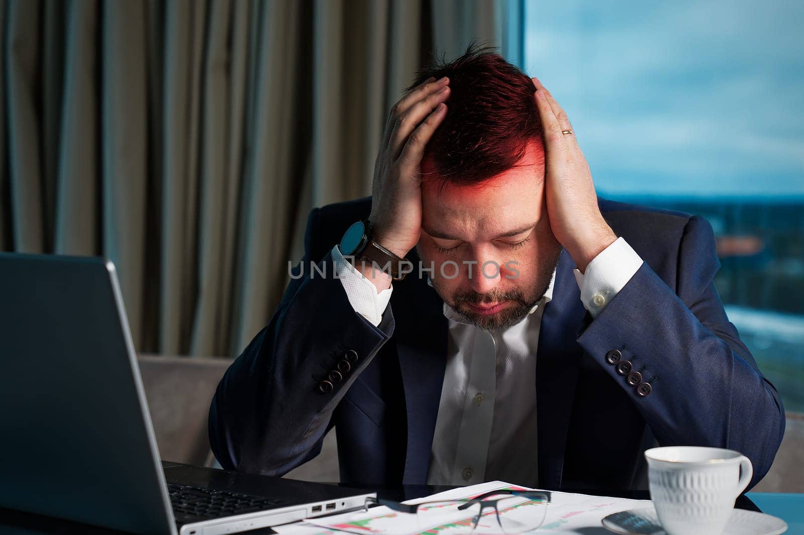 Tired man working at home office, Exhausted, stressed, overworked man, unsuccessful financial investments. by PhotoTime