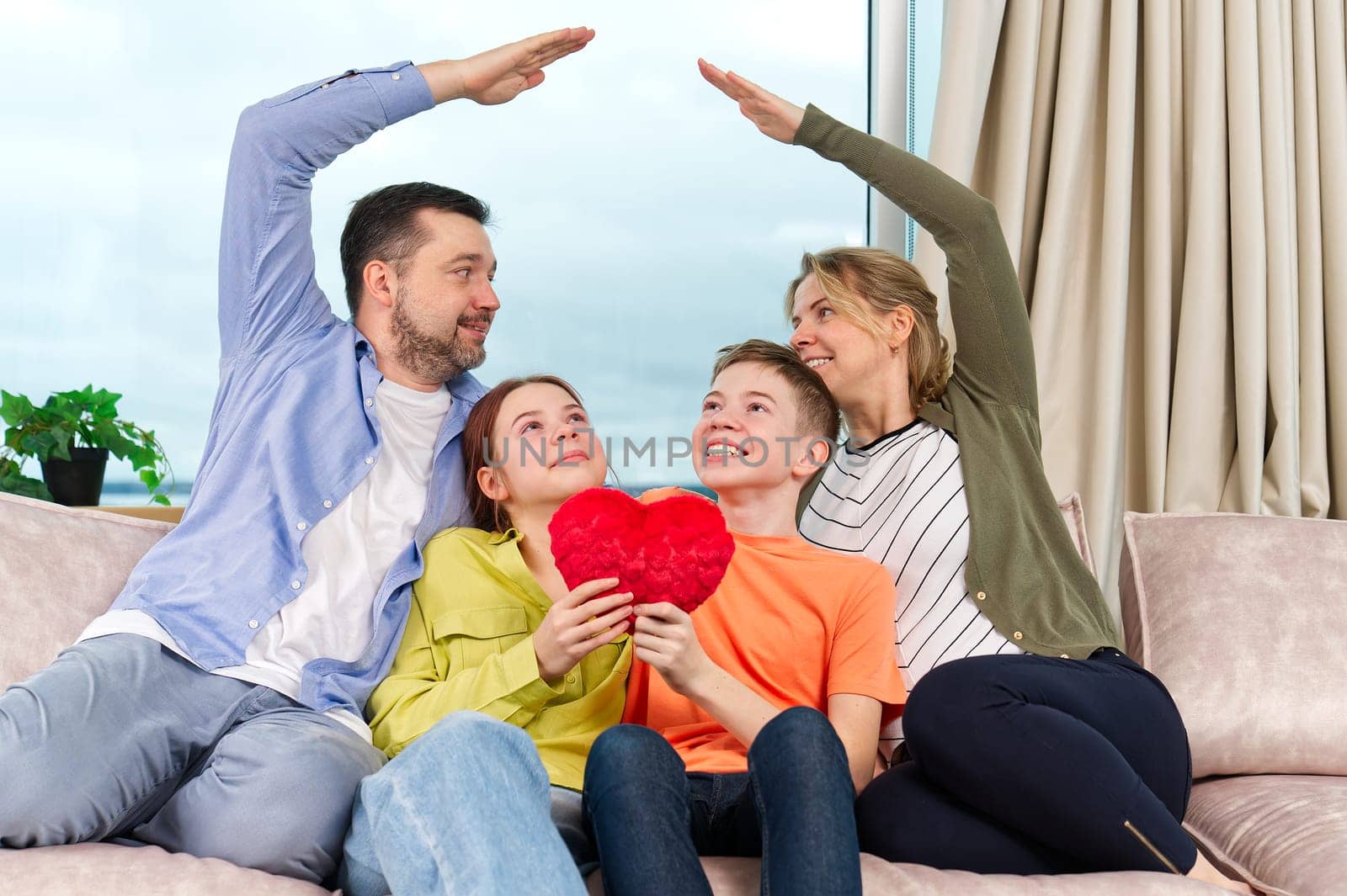 Happy family with kids sit on sofa in living room have fun. Smiling parents rest on couch enjoy weekend by PhotoTime