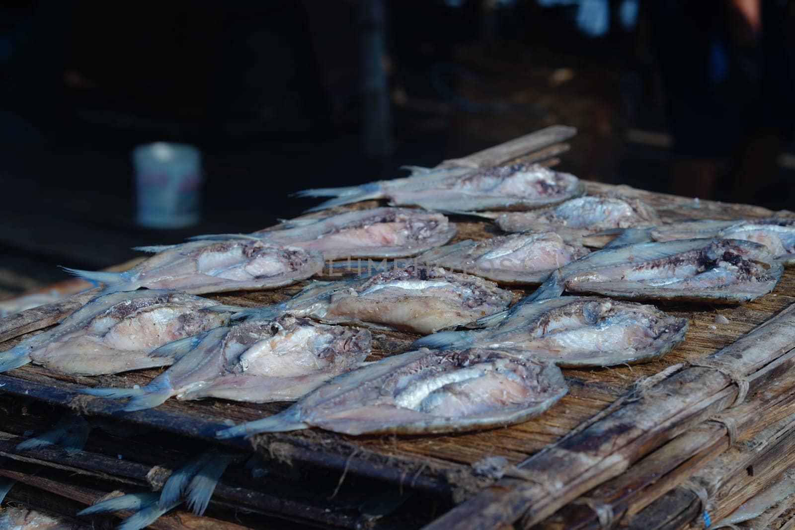 Traditional process of drying the salted fish under direct sunlight in Gresik, Indonesia. Street Photography