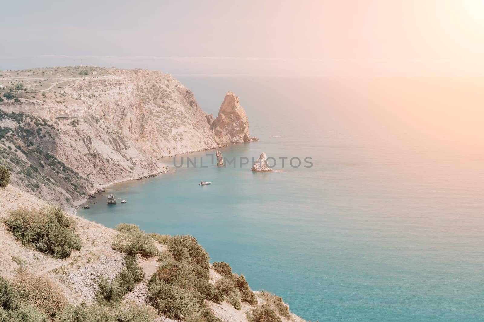 Aerial panoramic view of beautiful sunset above sea. Beautiful seascape. Sun glare, small waves on the water surface. Evening. Horizon. Nobody. No people. Copy space. Never-ending beauty of nature