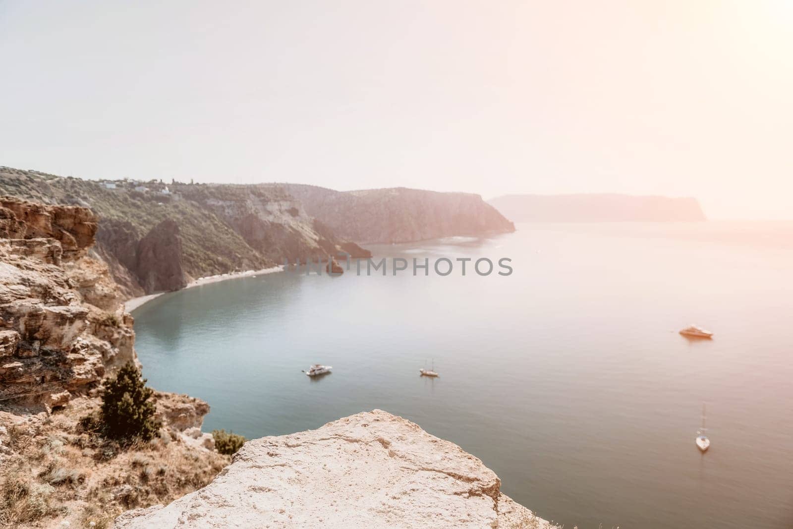 Aerial view from above on calm azure sea and volcanic rocky shores. Small waves on water surface in motion blur. Nature summer ocean sea beach background. Nobody. Holiday, vacation and travel concept by panophotograph