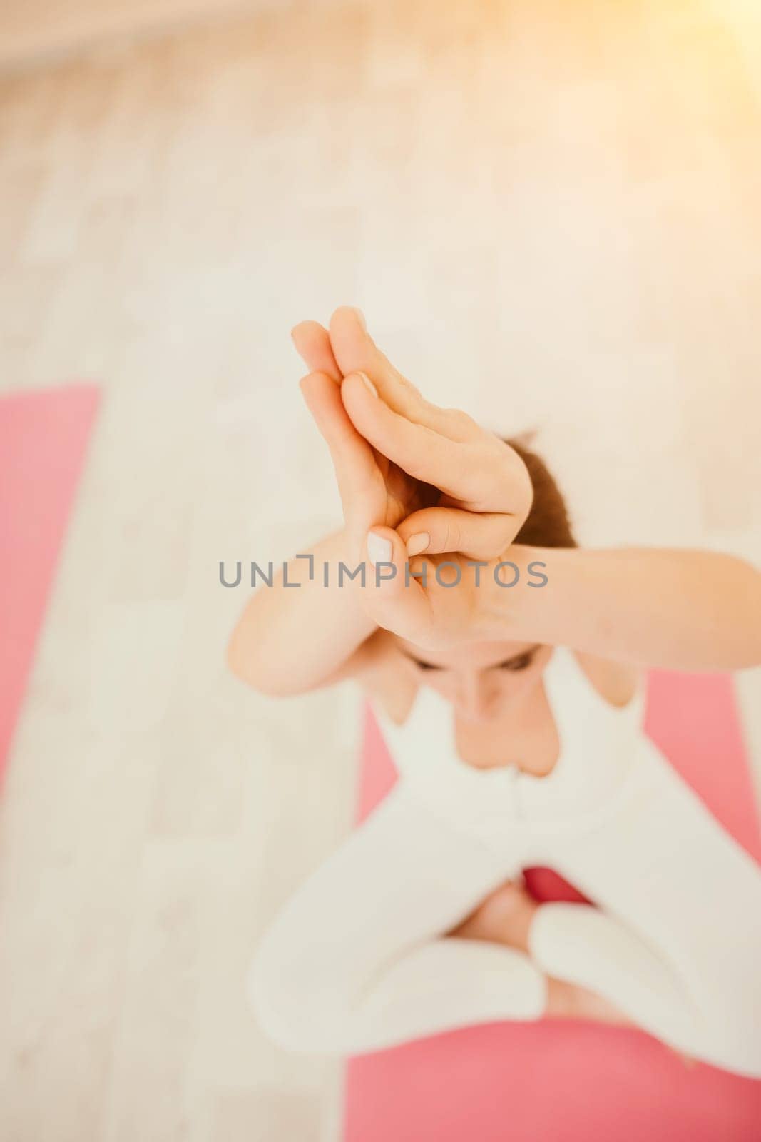 Two young sporty woman, fitness instructor in sportswear doing stretching and pilates on yoga mat in the studio with mirror. Female fitness yoga routine concept. Healthy lifestyle and harmony. by panophotograph