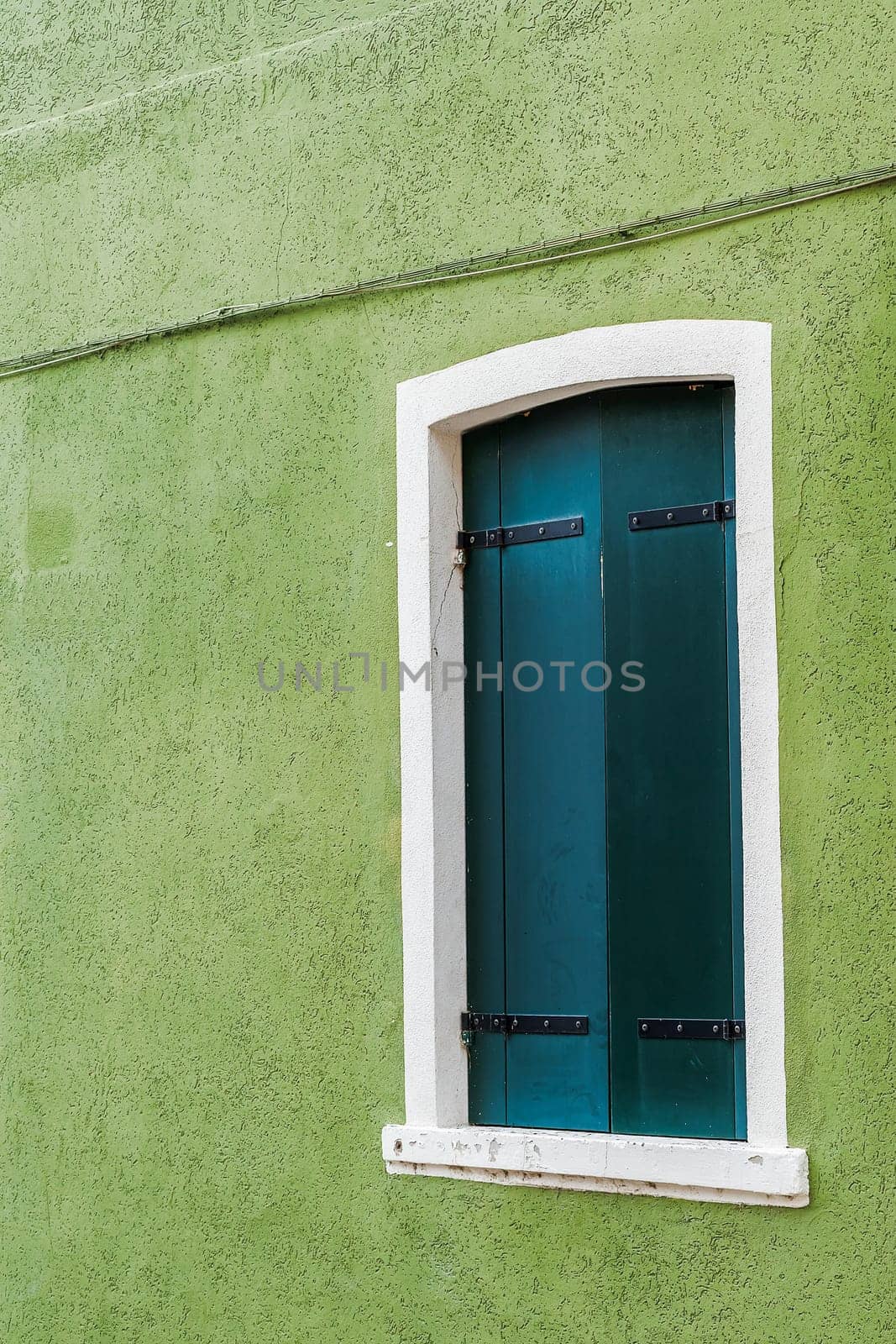 A window of one of the characteristic colored houses of Burano (Venice)