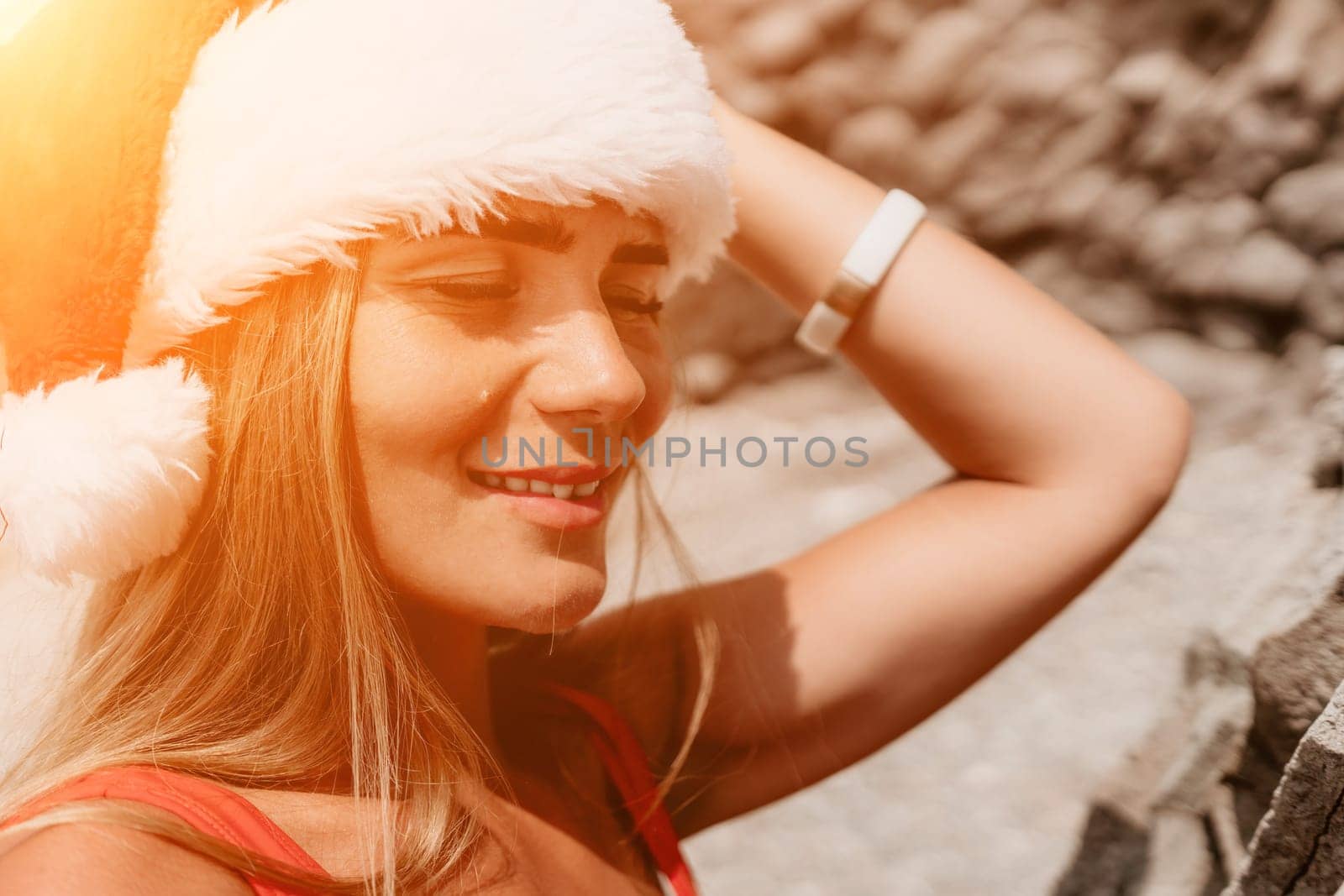 Woman travel sea. Young Happy woman in a long red dress posing on a beach near the sea on background of volcanic rocks, like in Iceland, sharing travel adventure journey