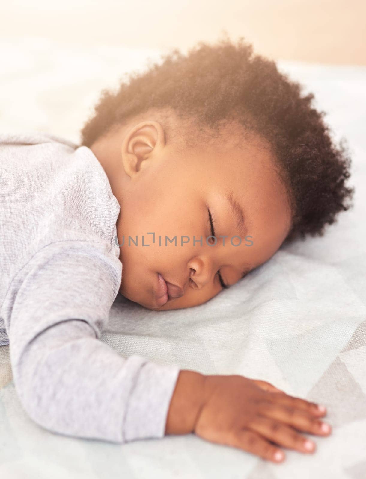 Tired, bed and baby sleeping in home on blanket for rest, nap time and dreaming in nursery. Childcare, newborn and cute, adorable and African child in bedroom sleep for comfort, relaxing and calm.