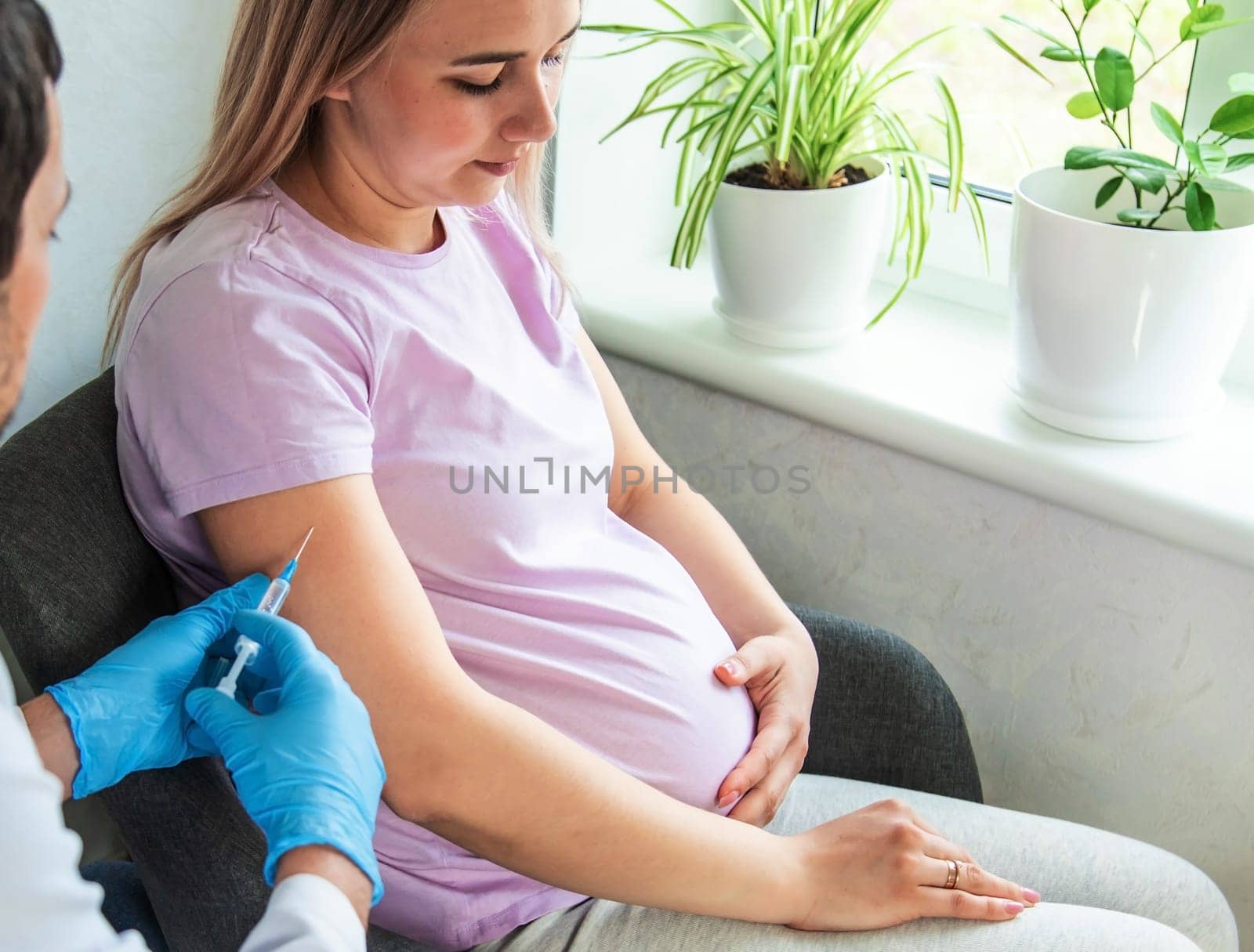 A pregnant woman makes a vaccination. Selective focus. doctor.
