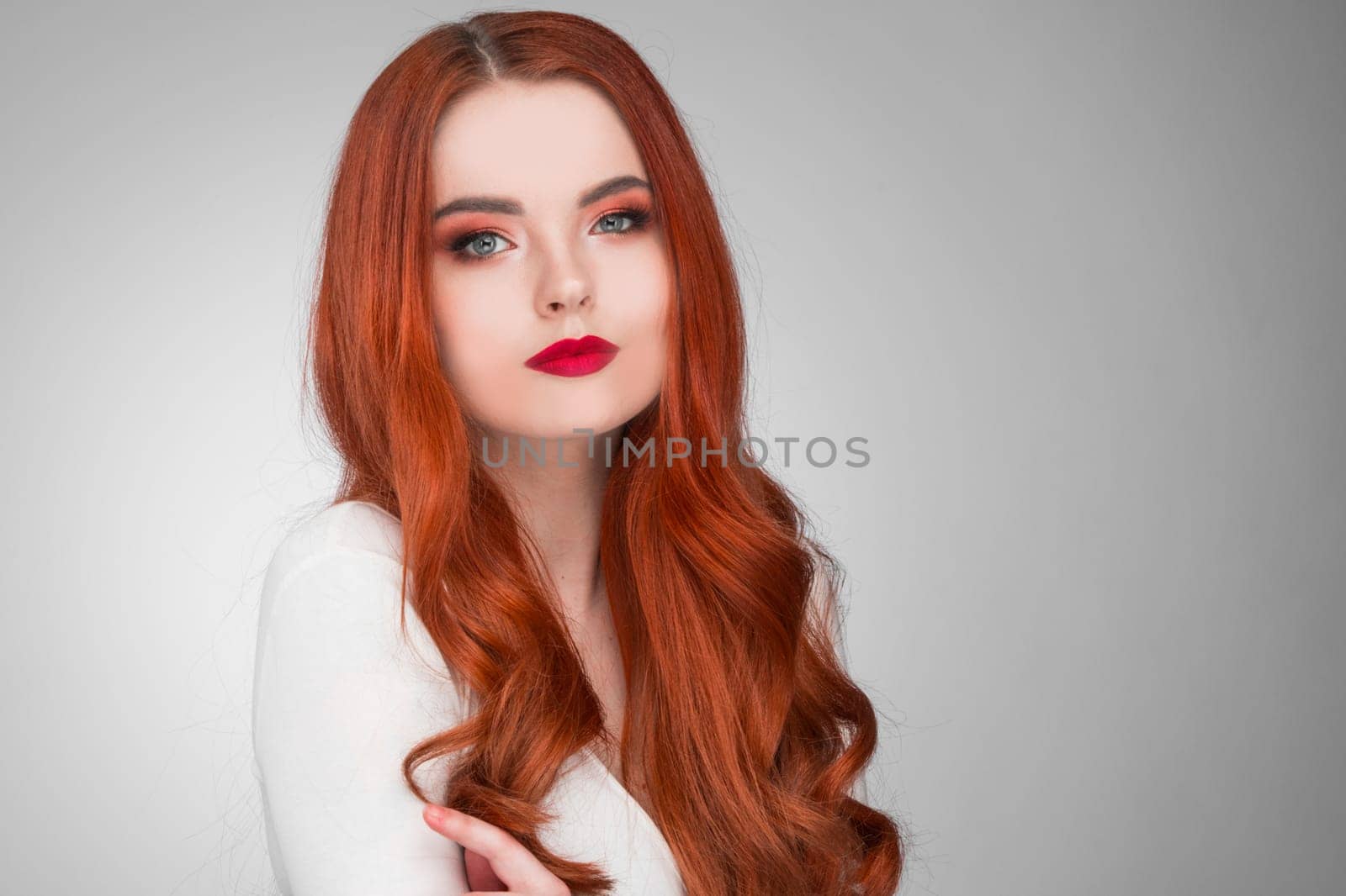 Beautiful Woman with Red Hair and bright makeup