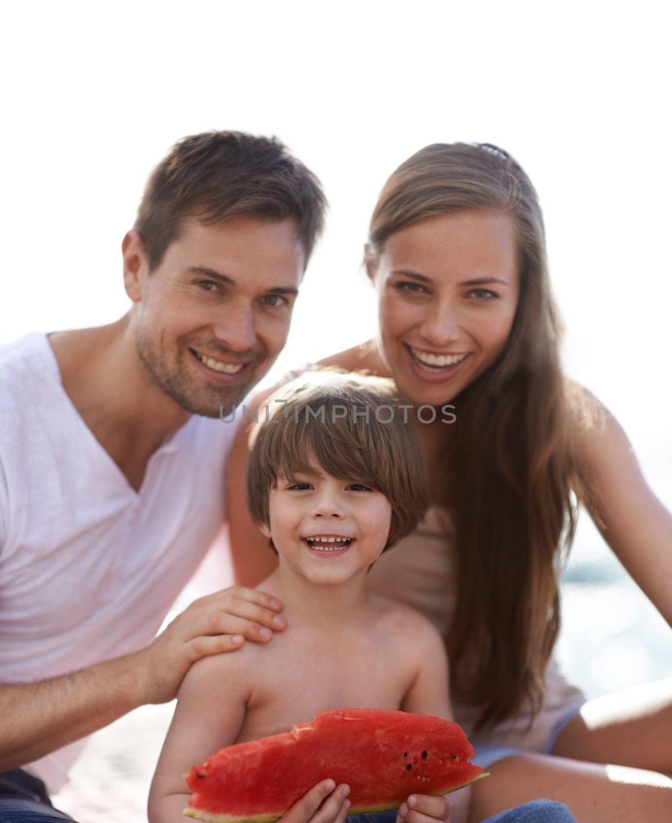 Family, watermelon and summer portrait at beach on travel holiday with a smile and fun. Man, woman and kid eating fruit and together on vacation at sea with love, care and happiness outdoor in nature.