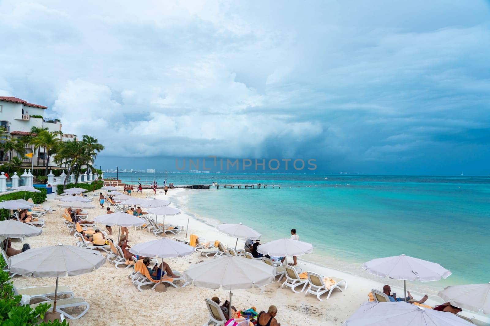 Cancun, Mexico - September 11, 2021: Tourists on the beach in all inclusive hotel in Cancun, Mexico. by Mariakray
