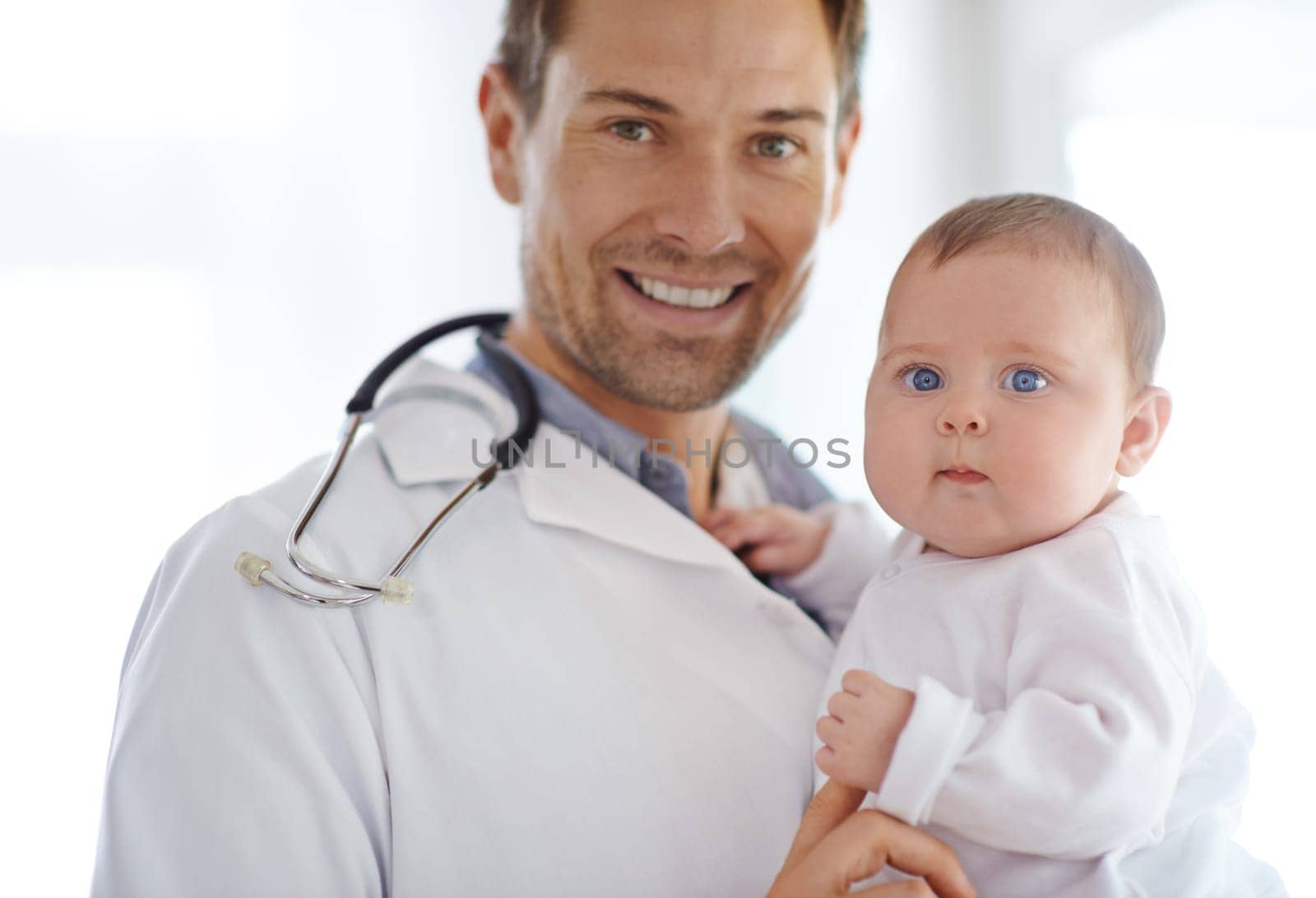 Portrait, happy man and pediatrician with baby for hospital assessment, medical support and growth. Pediatrics doctor holding newborn kid in clinic for healthcare service, trust and helping children.