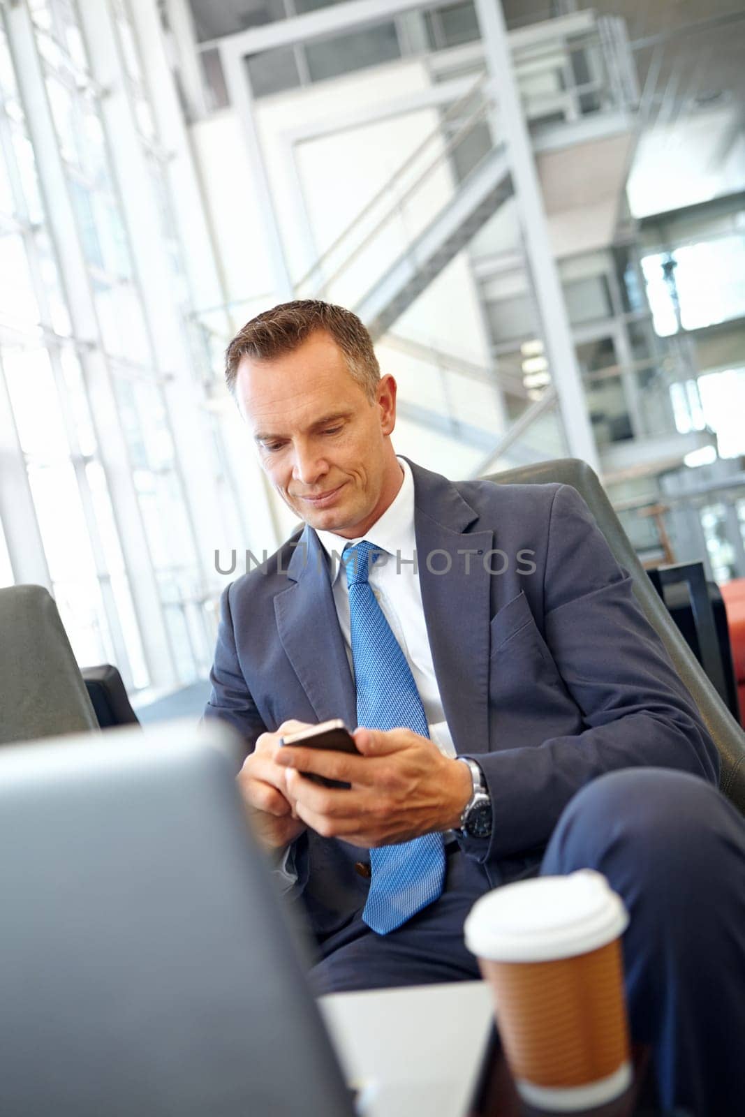 Business man, corporate travel and smartphone with senior executive and company communication with networking. Contact, online and email with CEO traveling to conference and waiting at airport.