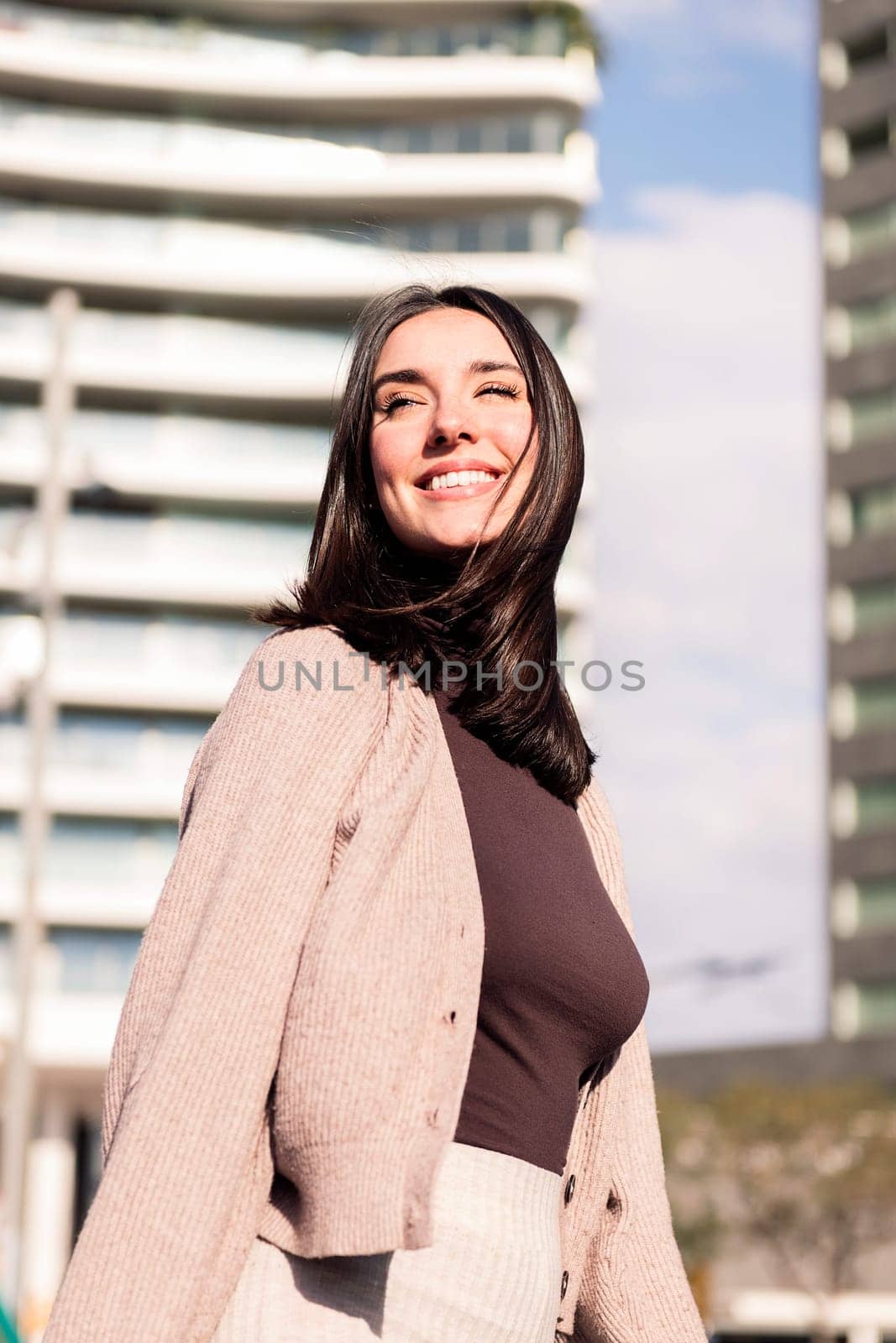 cheerful young woman smiling taking a walk in city streets, concept of happiness and urban lifestyle, copy space for text