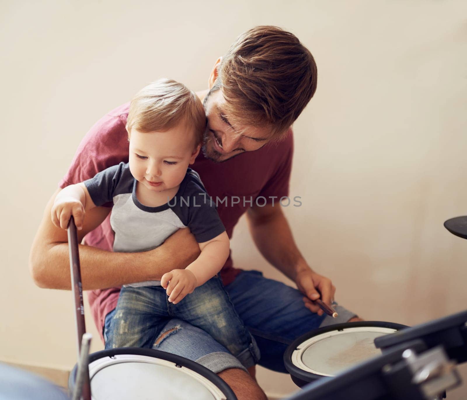 Dad, baby and drummer teaching for music development and child learning. Home, father happiness and kid instrument together with youth lesson with a smile, love and parent care at a family house.