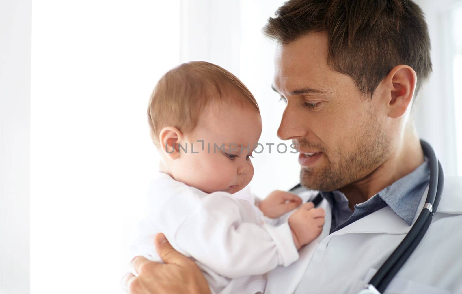 Man, pediatrician and holding baby for healthcare assessment, wellness consulting and service for children. Kids, medical doctor and newborn in clinic, hospital and expert consultation for pediatrics.
