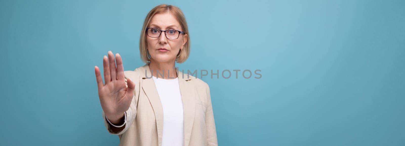 middle-aged woman business serious on bright studio background with copy space.